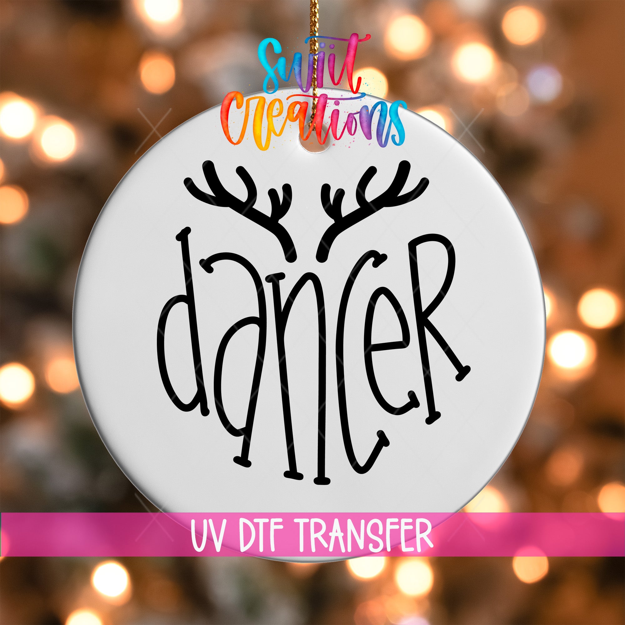 A white ornament with the word "dancer" written on it, hanging against a background of colorful lights.