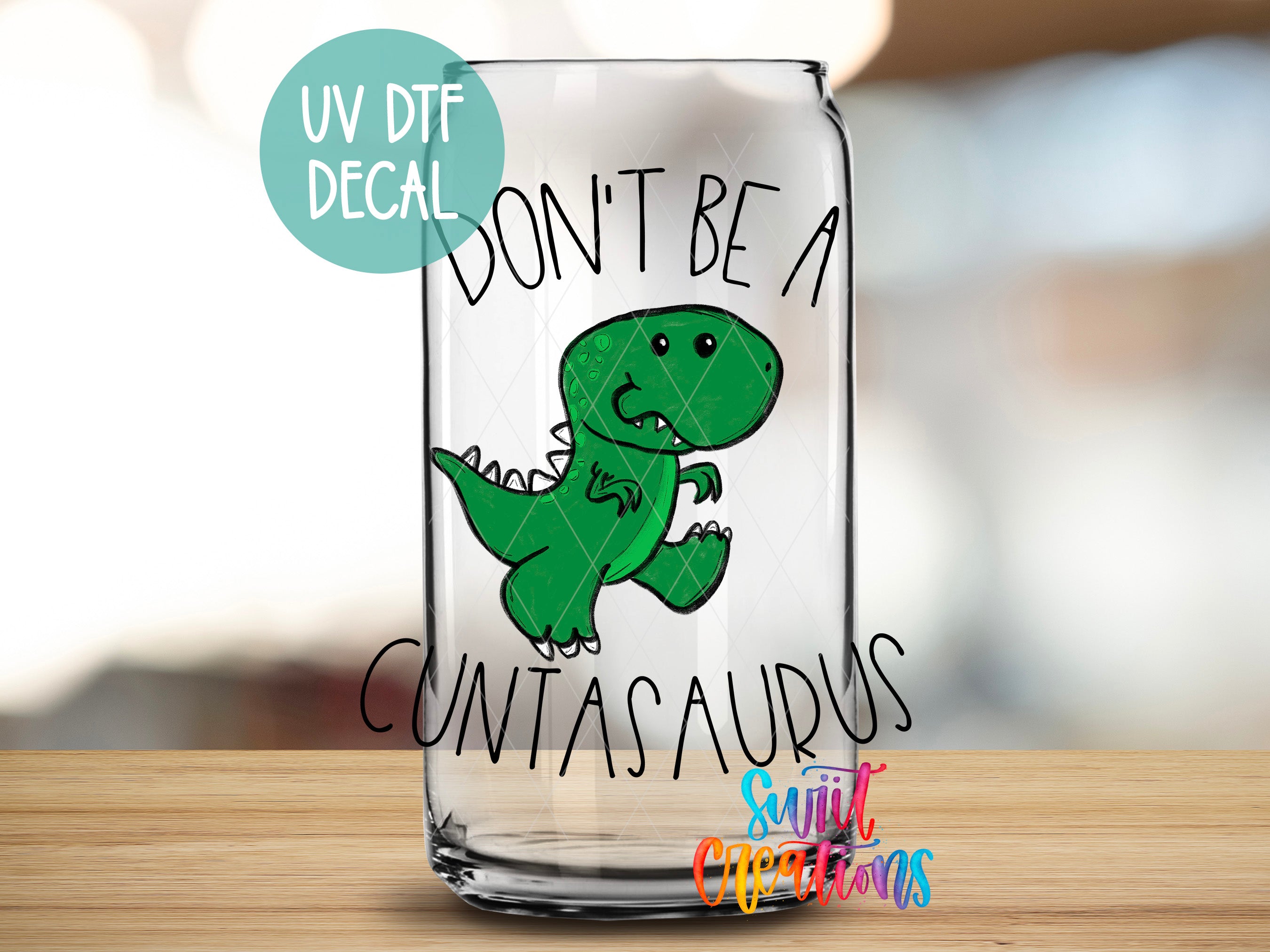 A glass can with a cartoon dinosaur and text printed on it.