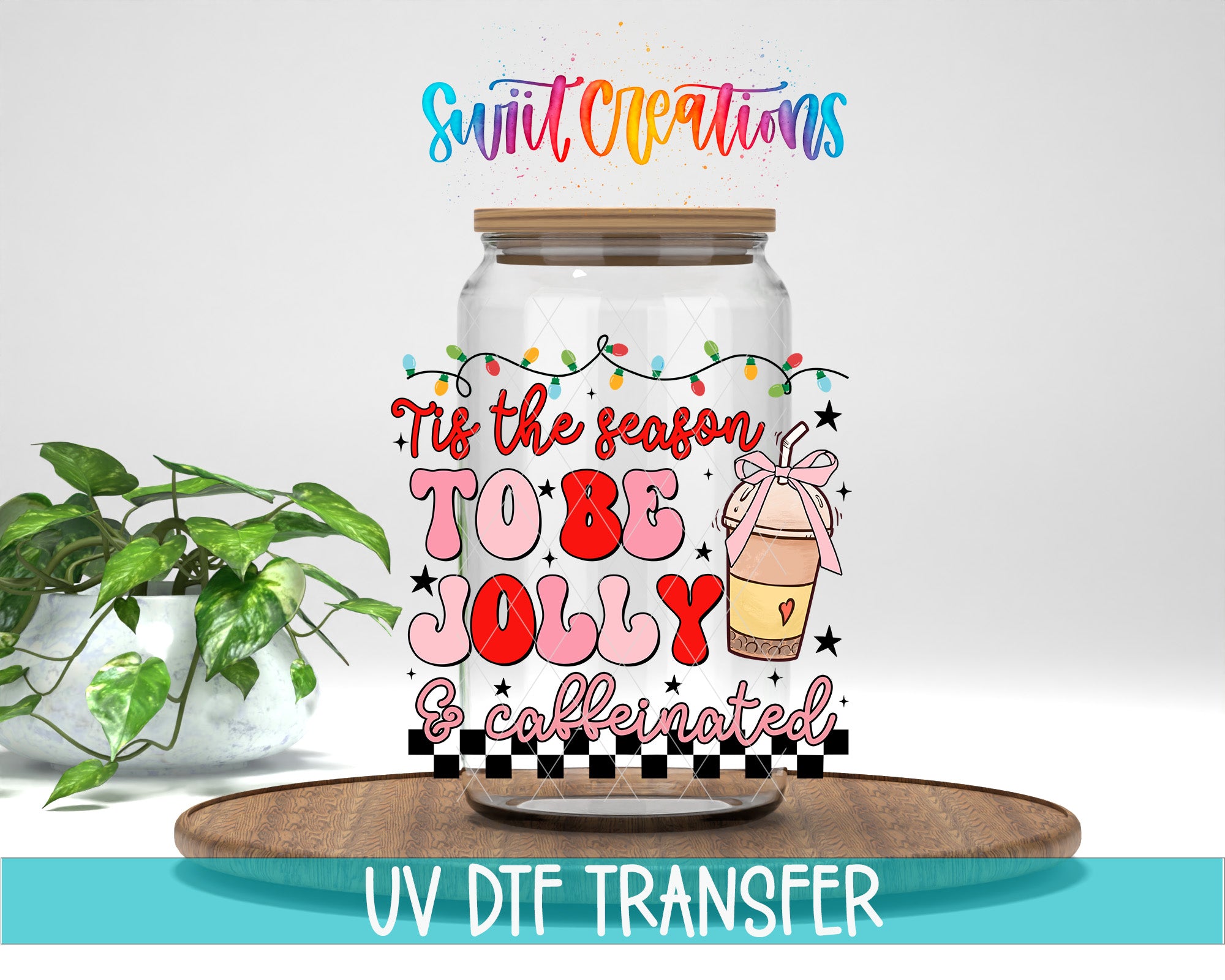 A glass jar with a label that says "Tis the season to be Jolly & caffeinated" and features a coffee cup and a ribbon. The jar is placed on a wooden tray, and there is a potted plant in the background.