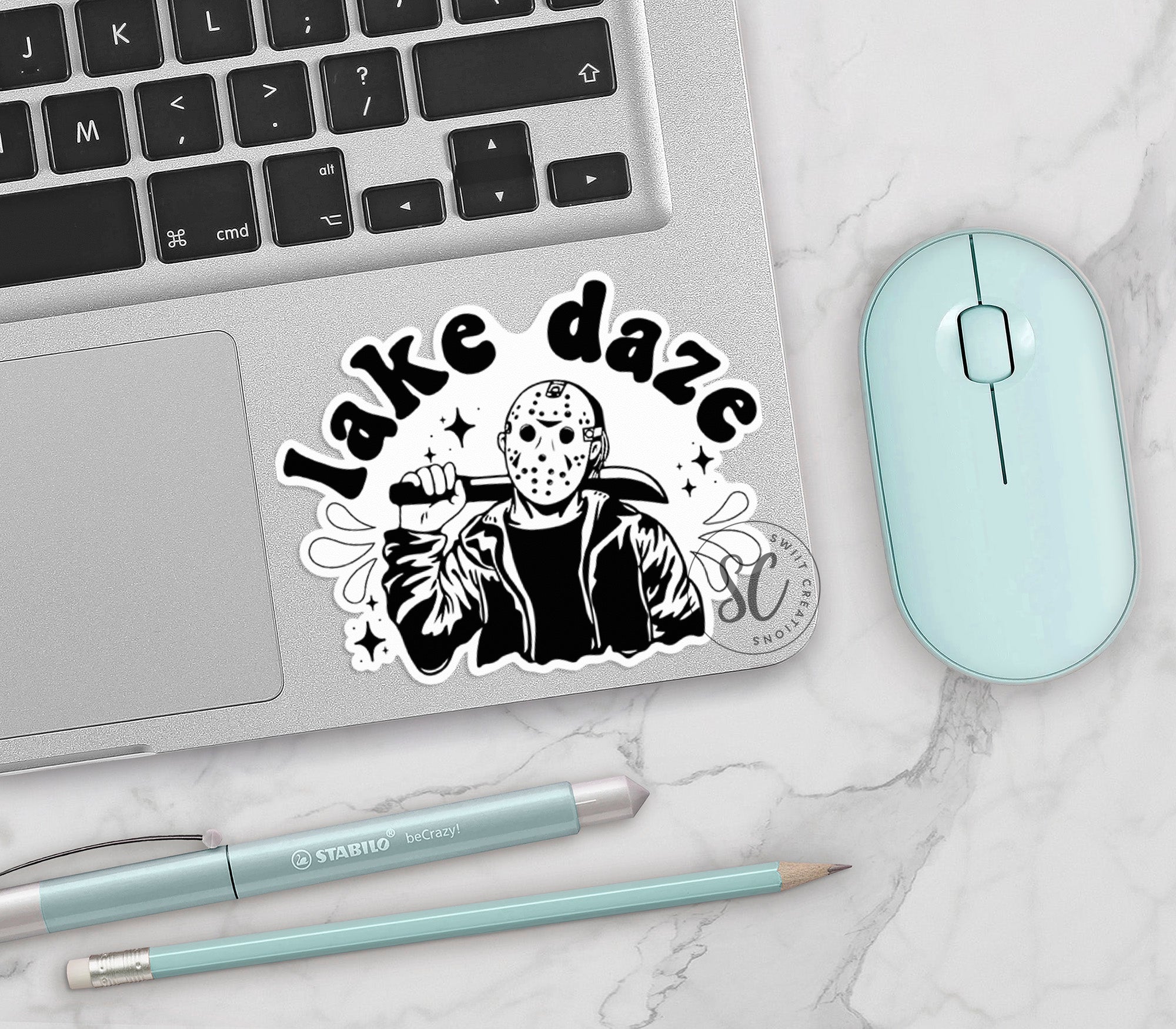 a laptop with a sticker on it next to a mouse