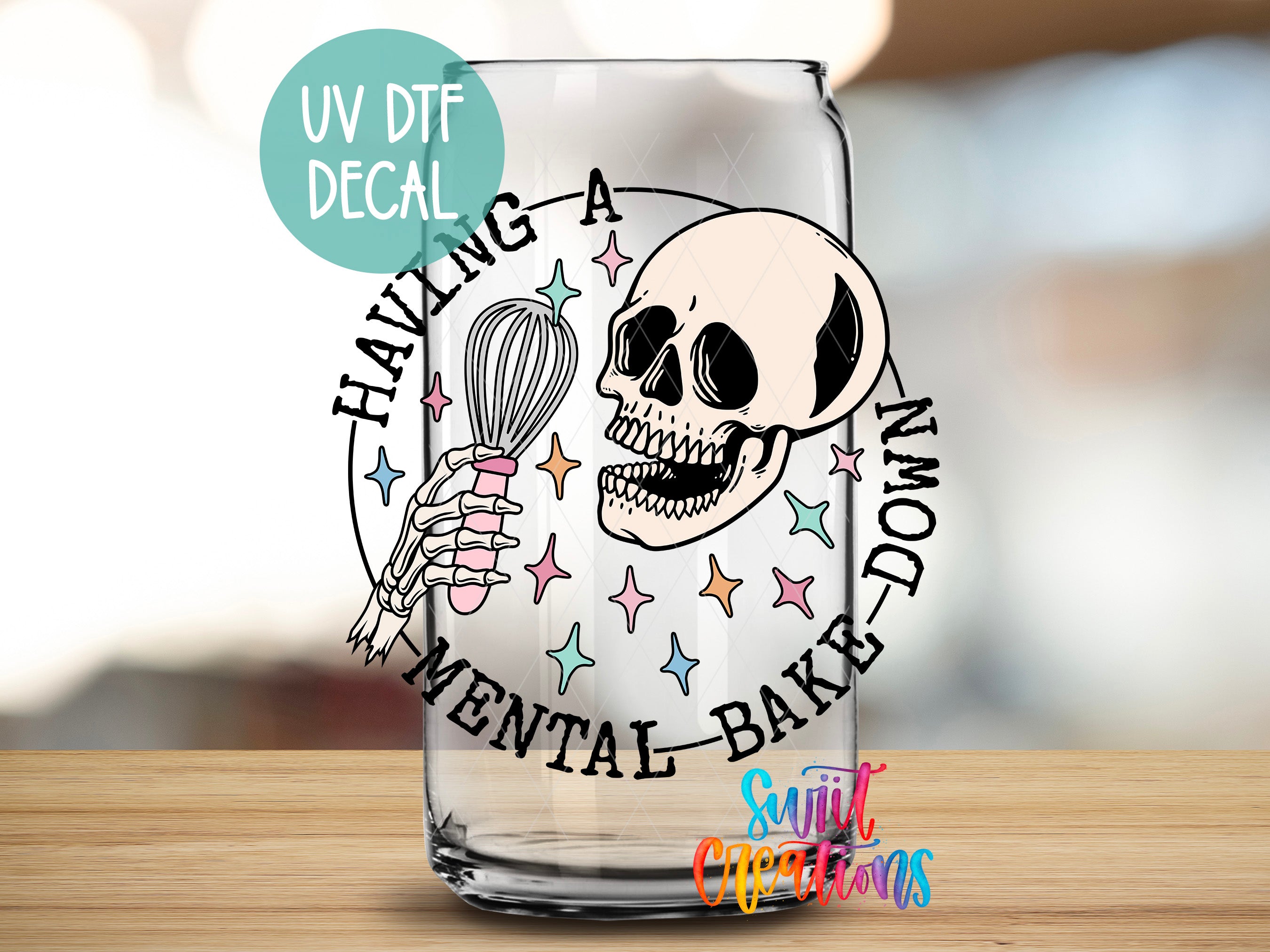 a shot glass with a skull holding a whisk