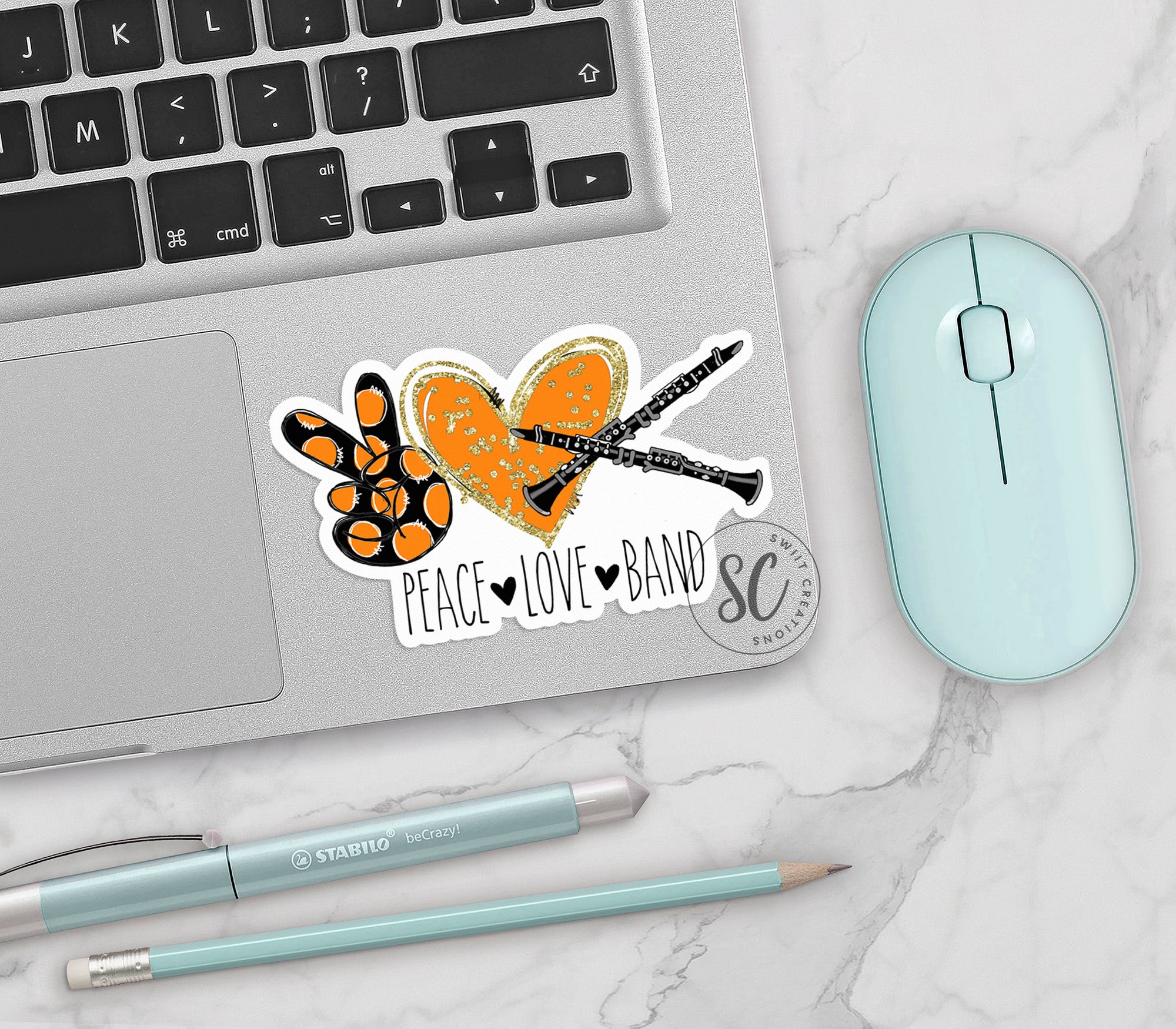 a laptop computer sitting on top of a desk next to a mouse