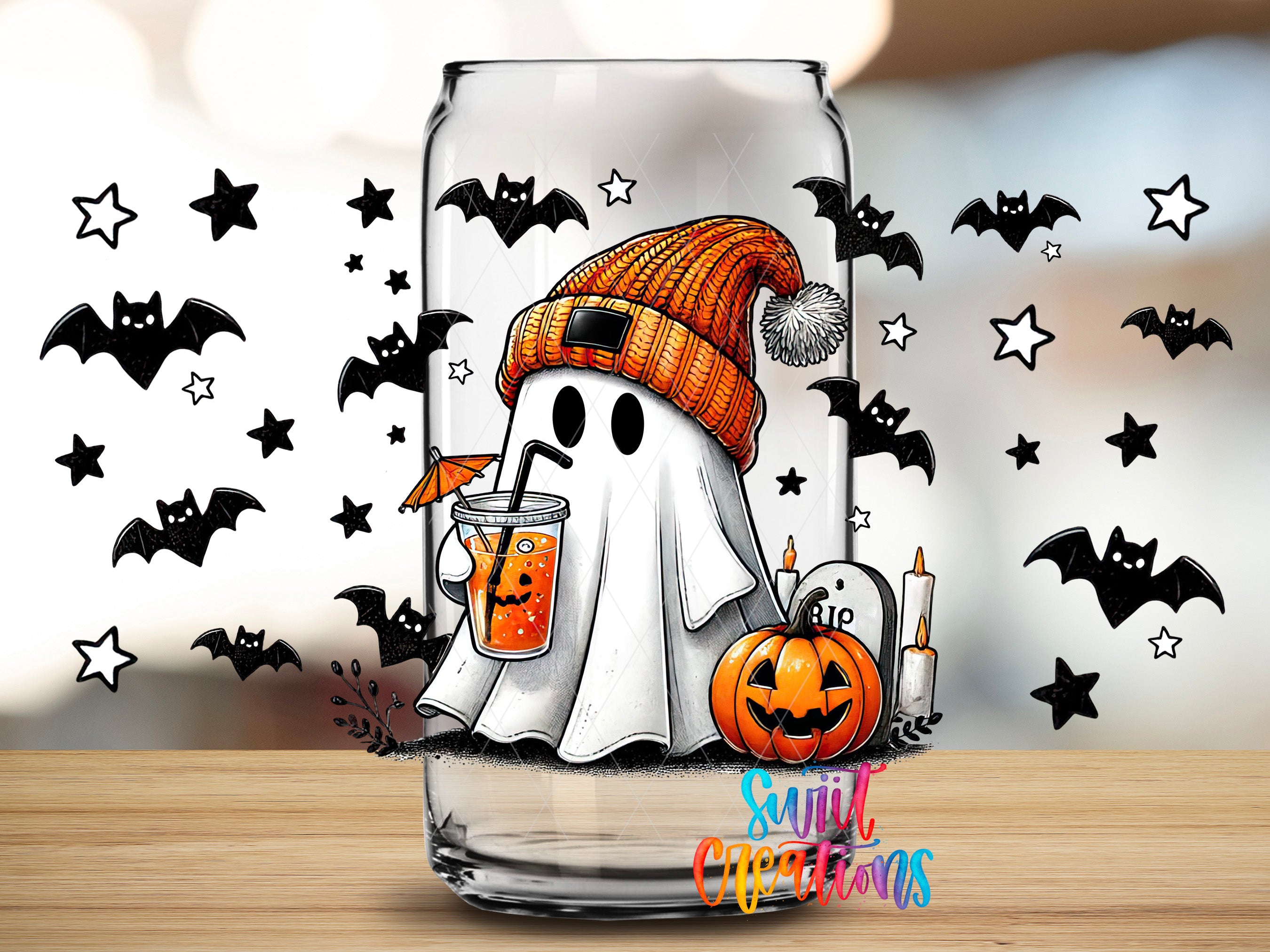 A Halloween-themed glass with a ghost wearing a knit hat and holding a drink, surrounded by bats and stars.