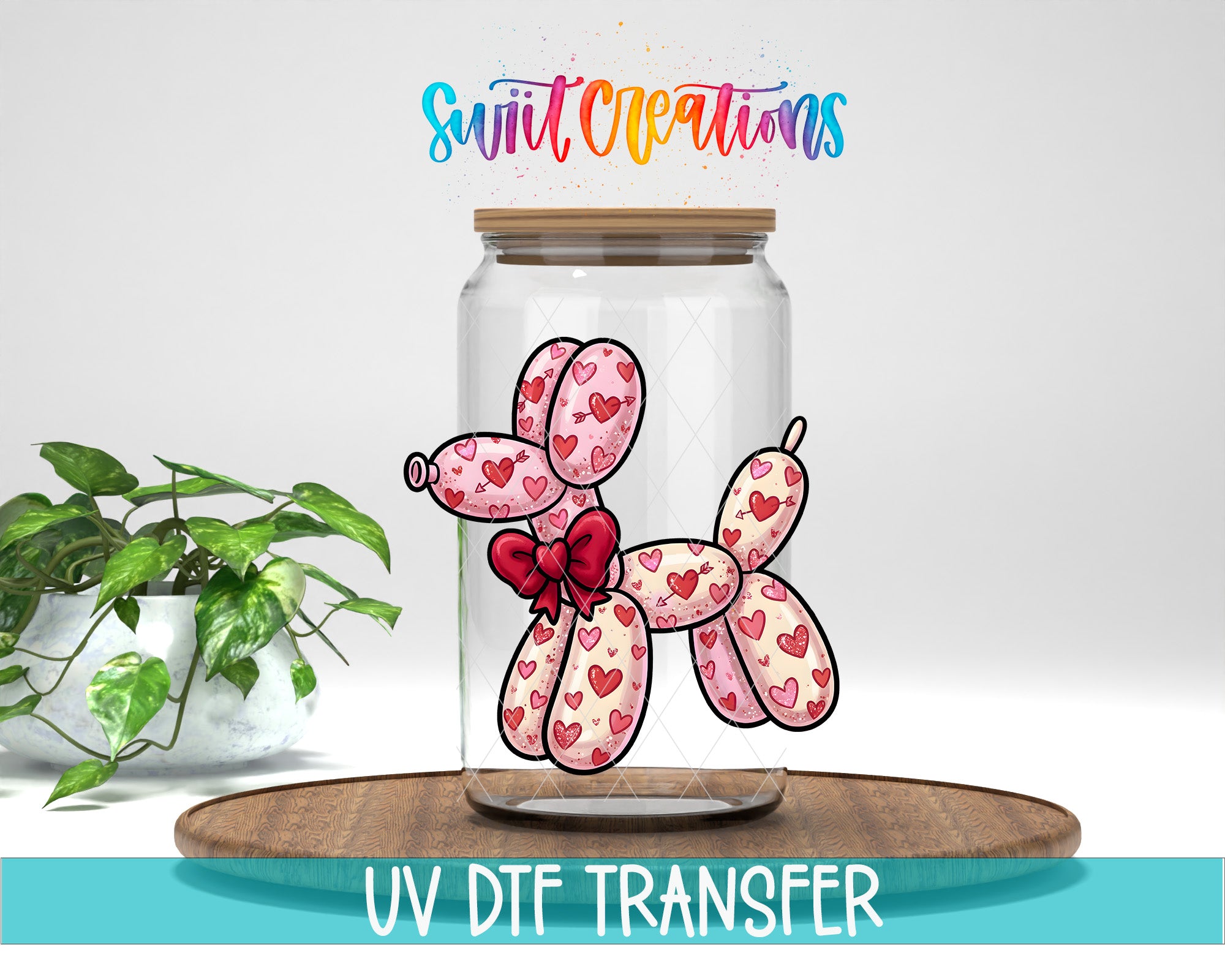 A glass jar containing a balloon dog with heart patterns, placed on a wooden surface next to a potted plant.