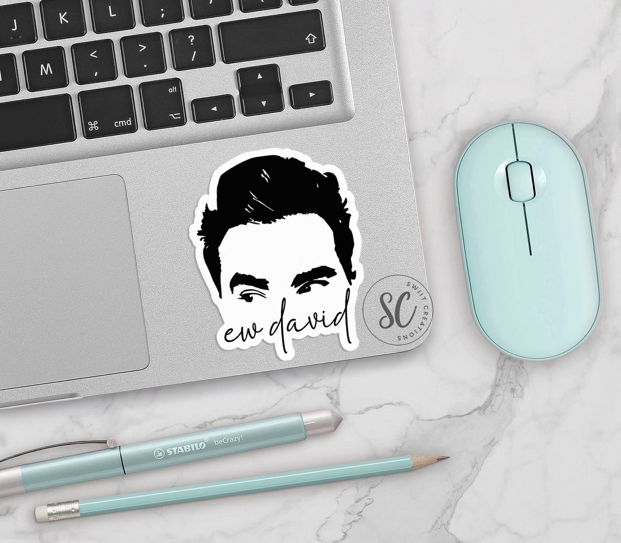 a laptop with a sticker of a man's face