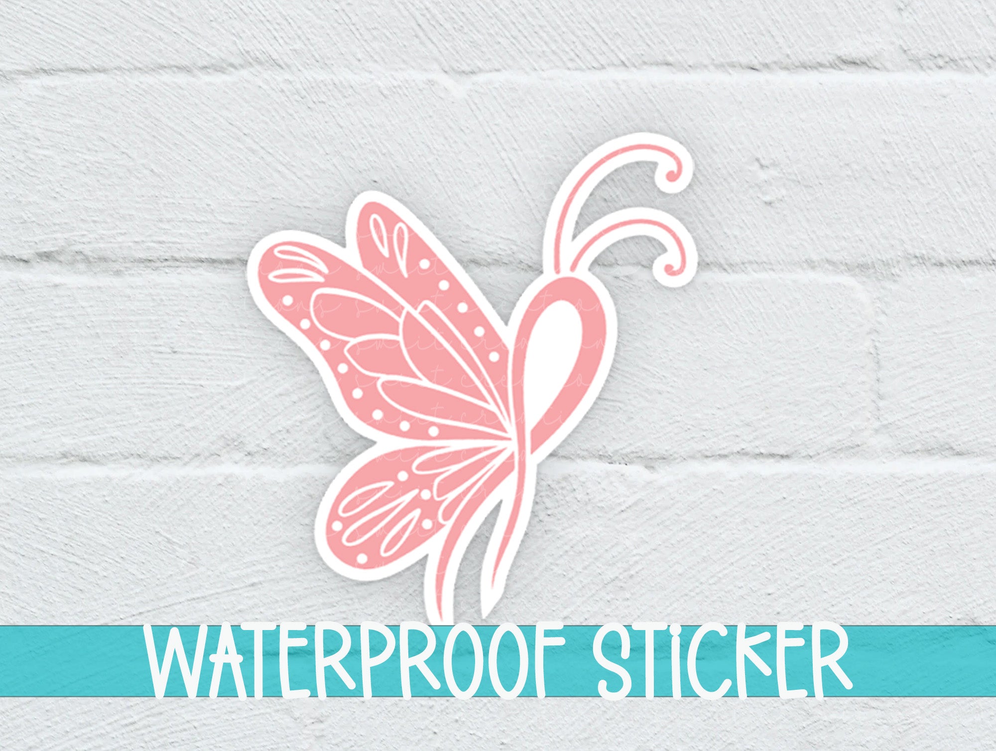 a pink butterfly sticker on a white brick wall
