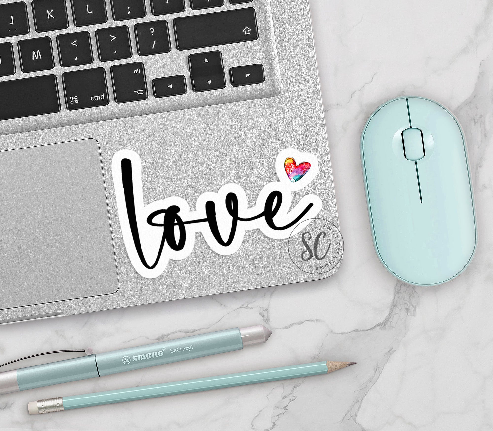 a laptop computer sitting on top of a desk next to a mouse