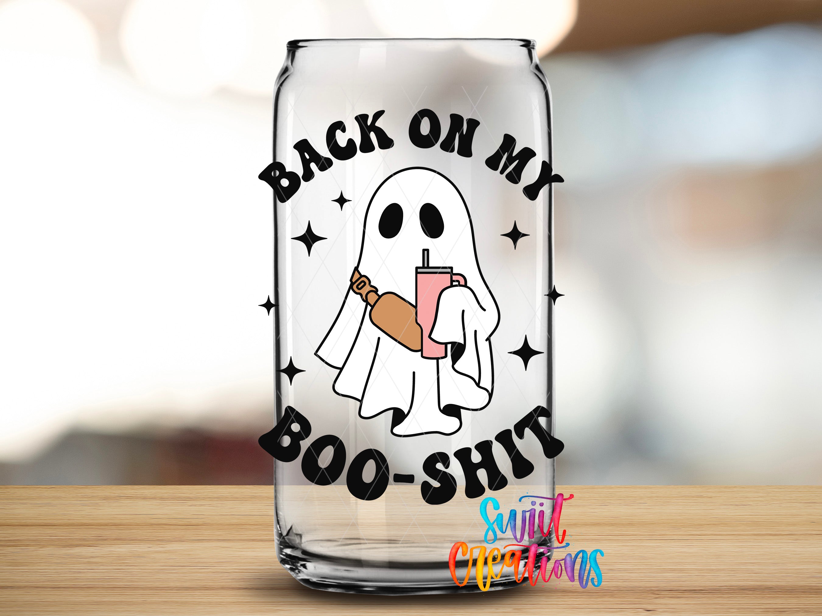 A glass can with a graphic design featuring a ghost holding a drink and the text "BACK ON MY BOO-SHIT" printed on it.