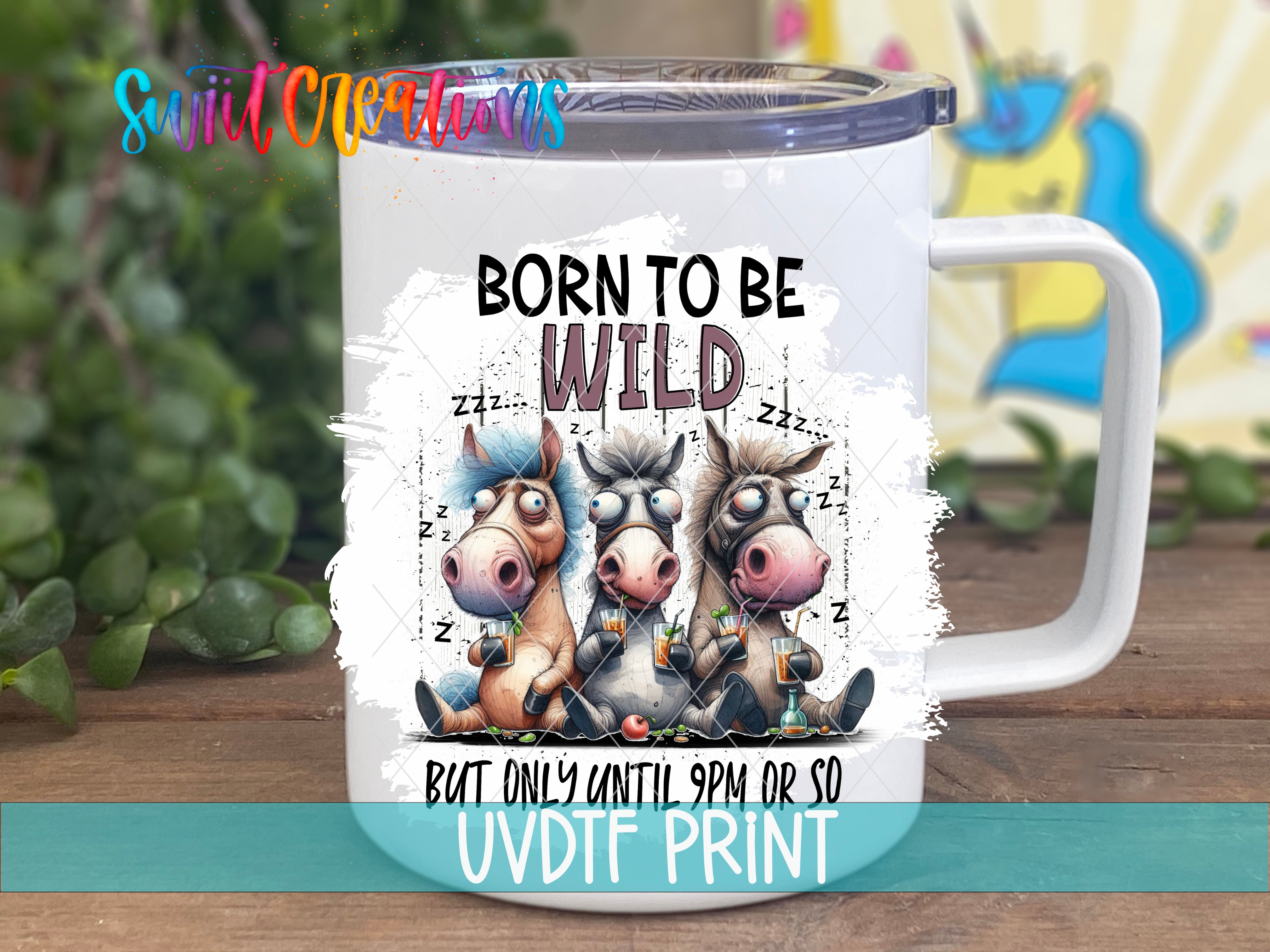 A white mug with a printed design featuring three cartoon horses and the text "Born to be wild" along with the phrase "But only until 9pm or so".