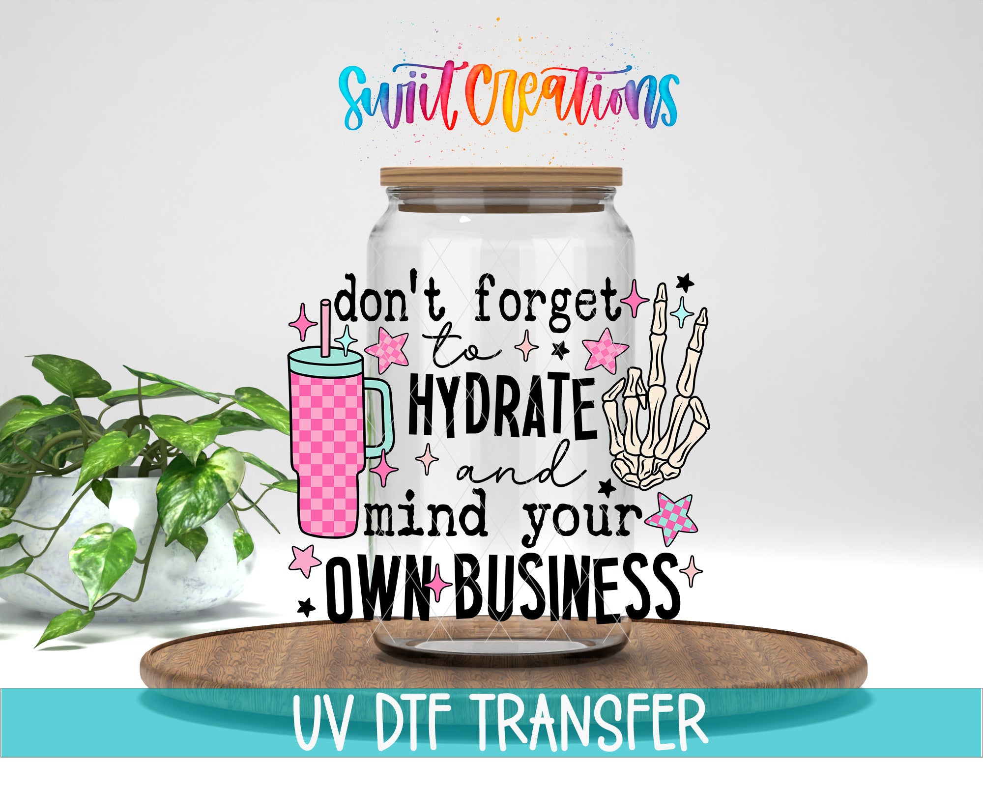 a glass jar with a colorful design and text, placed on a wooden surface.