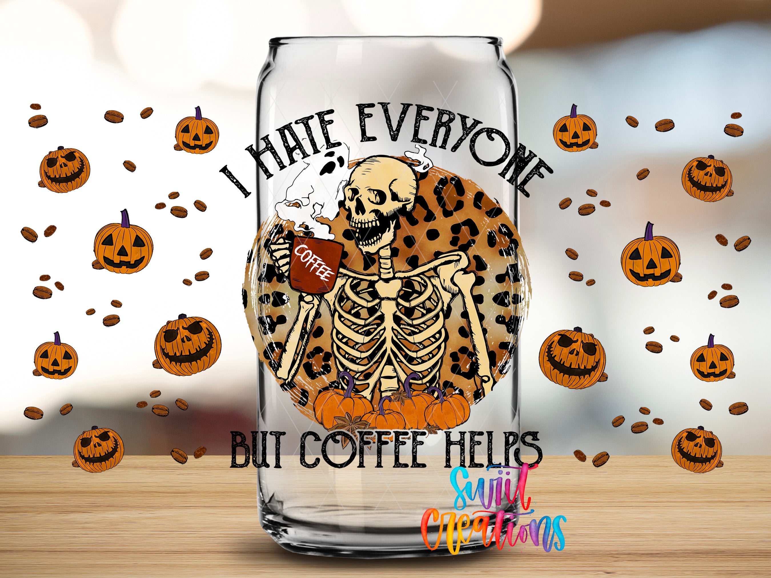 A glass mug with a skeleton holding a coffee cup, surrounded by Halloween pumpkins and coffee beans, with the text "I HATE EVERYONE BUT COFFEE HELPS" and "Silly Christmas" written on it.