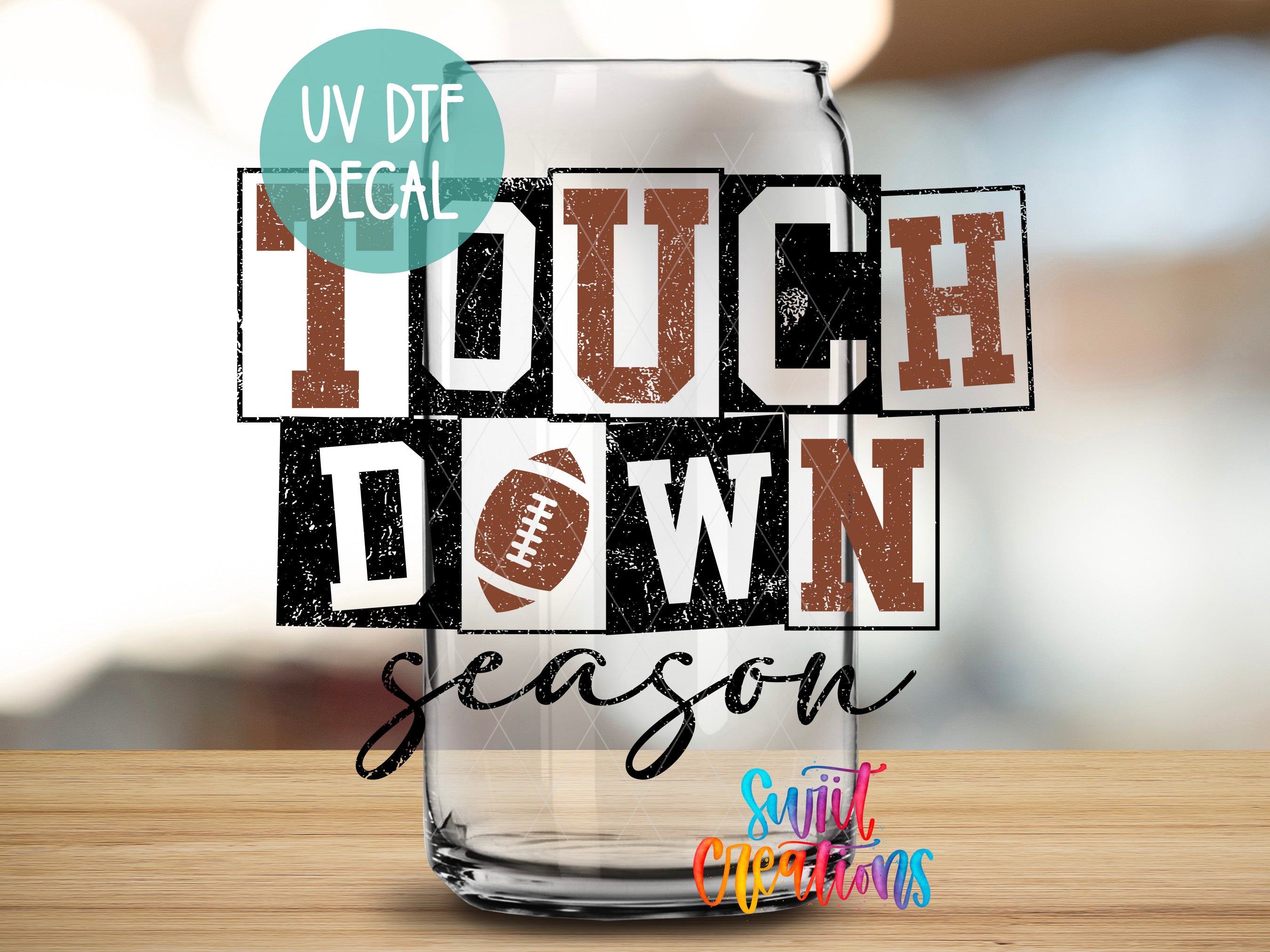 a glass with the words touch down and a football on it
