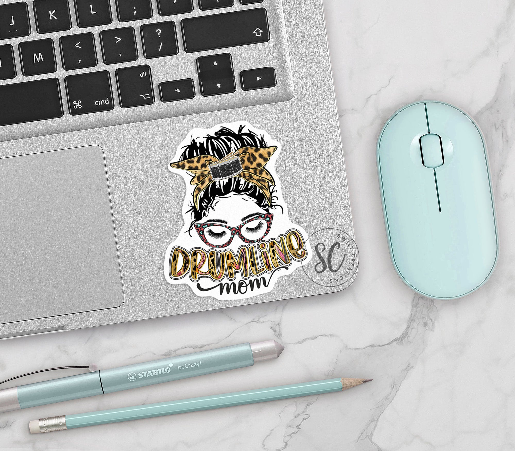 a laptop with a sticker of a woman's face on it