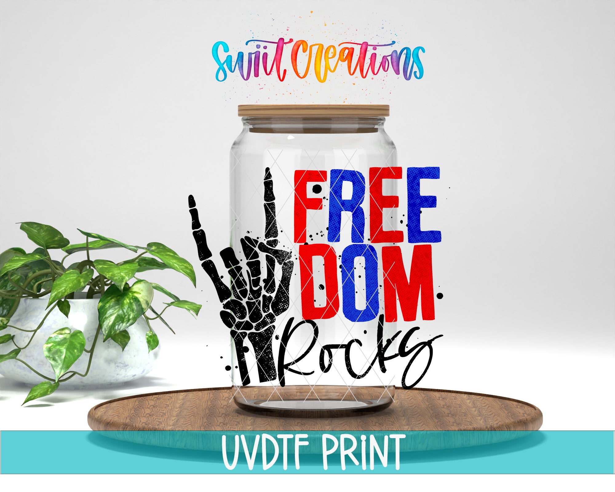 a glass jar with a hand-drawn skeleton and the text "FREE DOM ROCKS" printed on it, placed on a wooden surface.