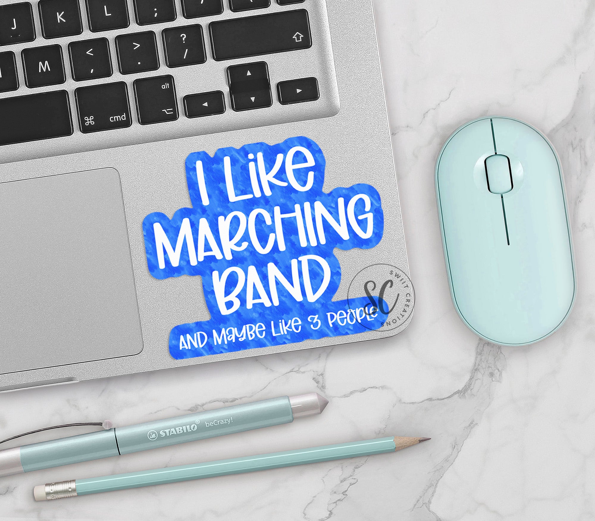 a keyboard, mouse, and sticker on a marble surface