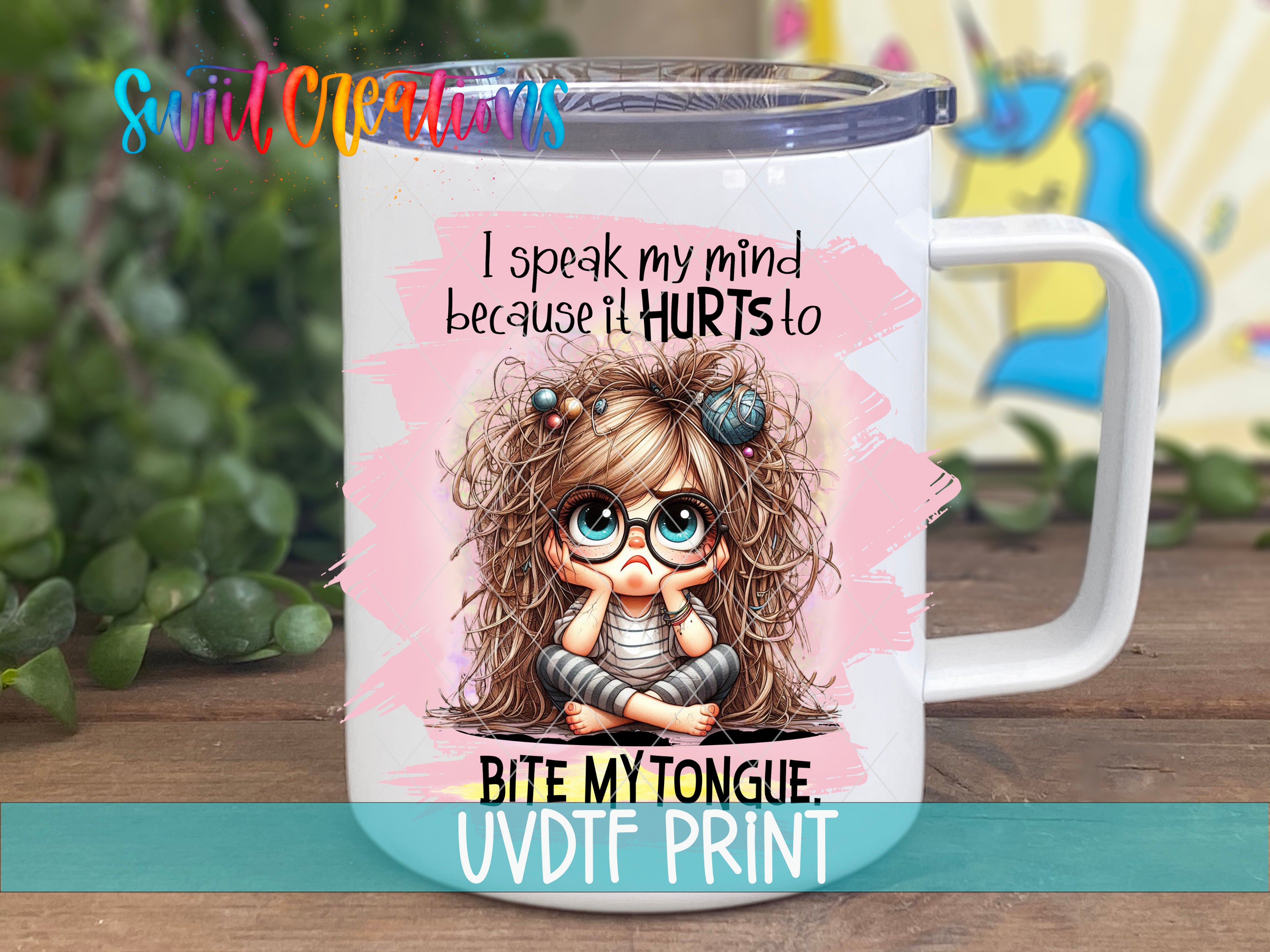 A white mug with a cartoon image of a young girl with messy hair and glasses, along with text that says "I speak my mind because it Hurts to Bite My Tongue UVDF Print".