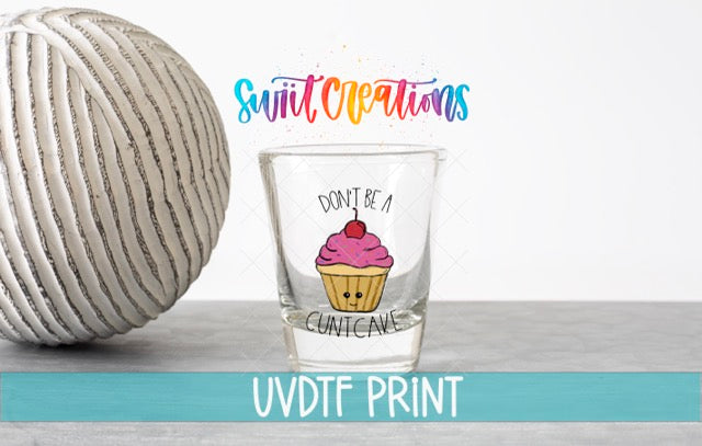 a shot glass with a cupcake design and the text "Don't be a Cuntcake" printed on it, along with a colorful text overlay that says "Swift Creations" and "UVDF PRINT".