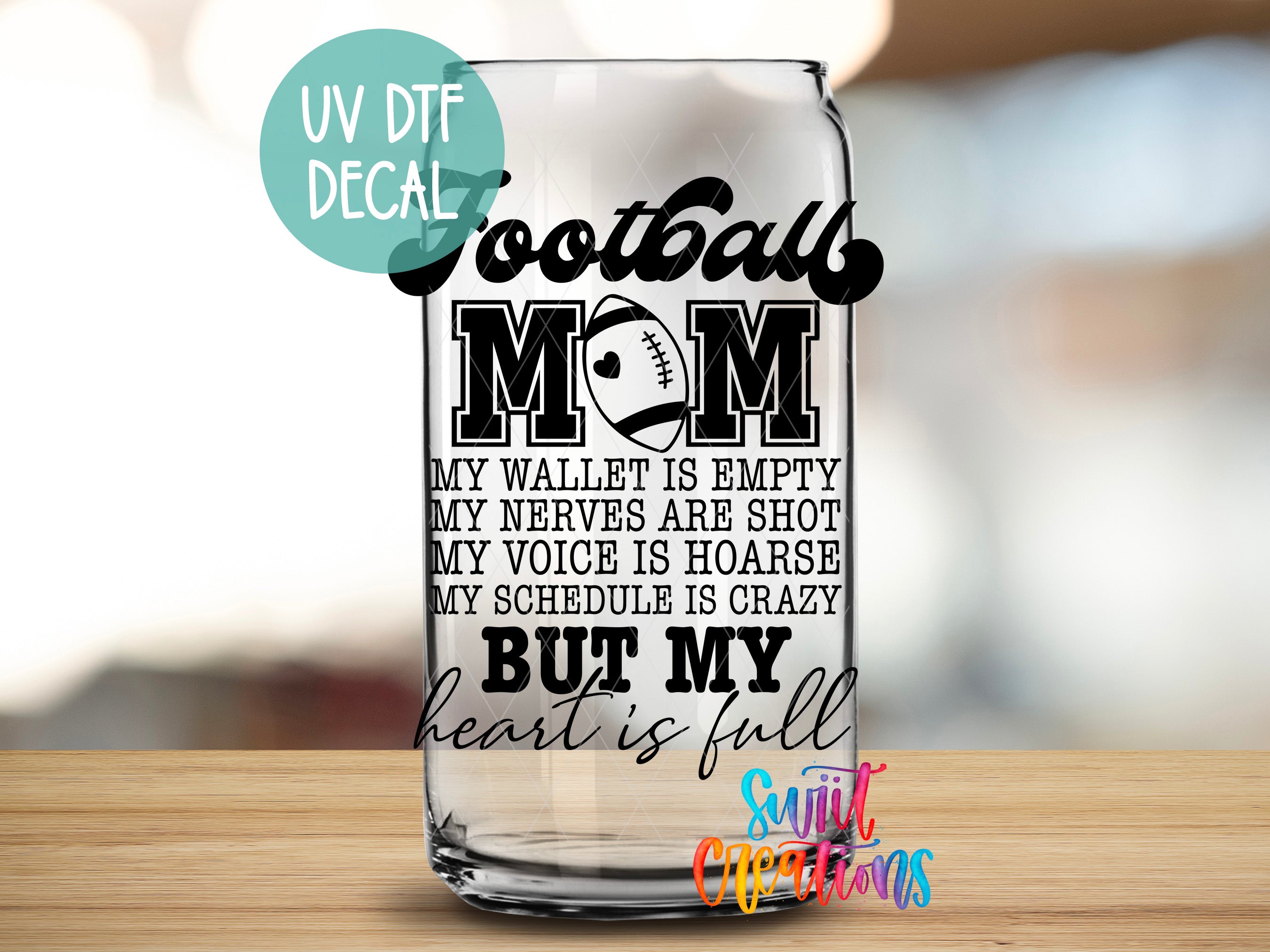 a glass with a football mom saying on it