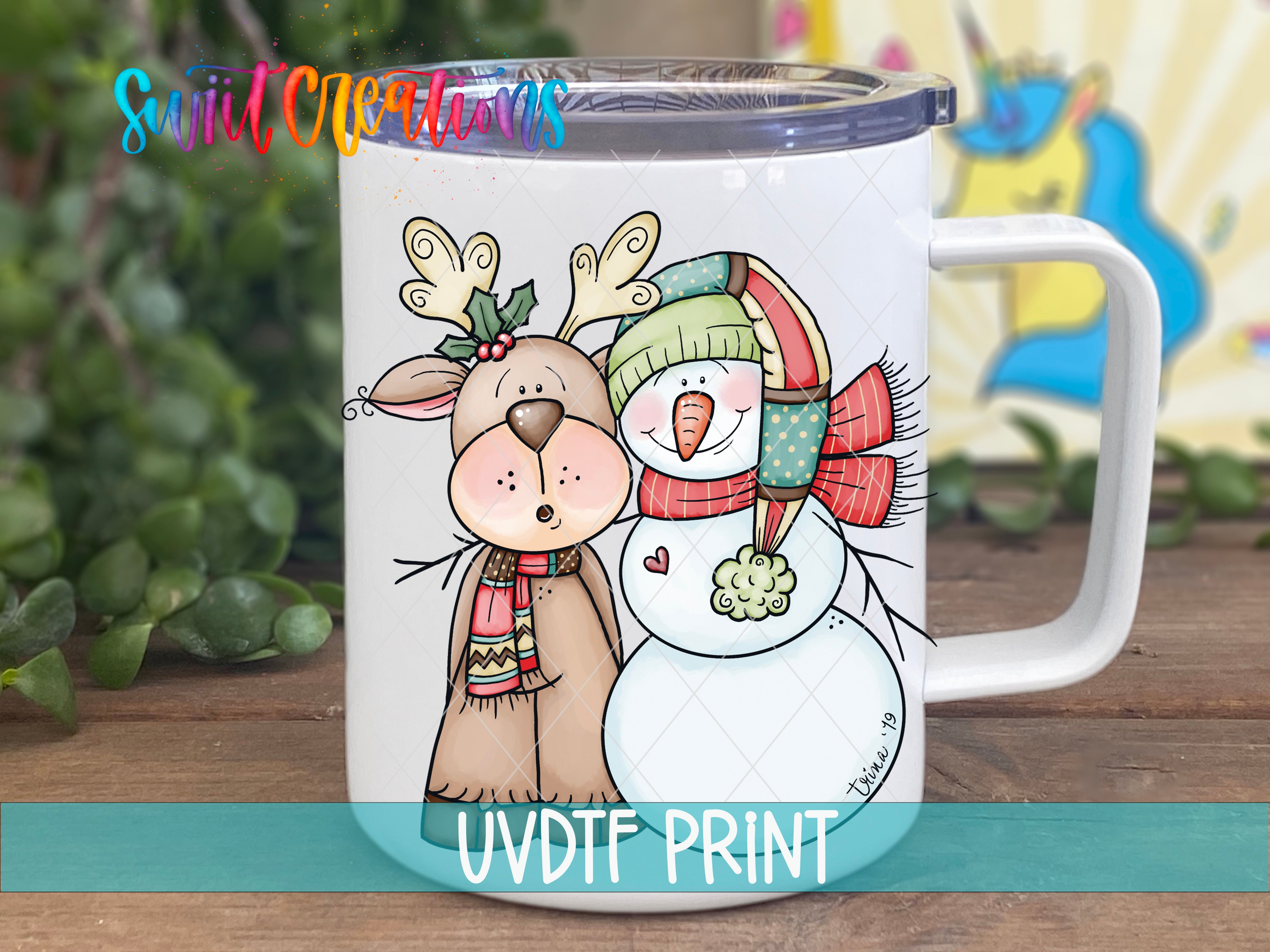 A mug with a cartoon illustration of a reindeer and a snowman, along with the text "UVDF PRINT".