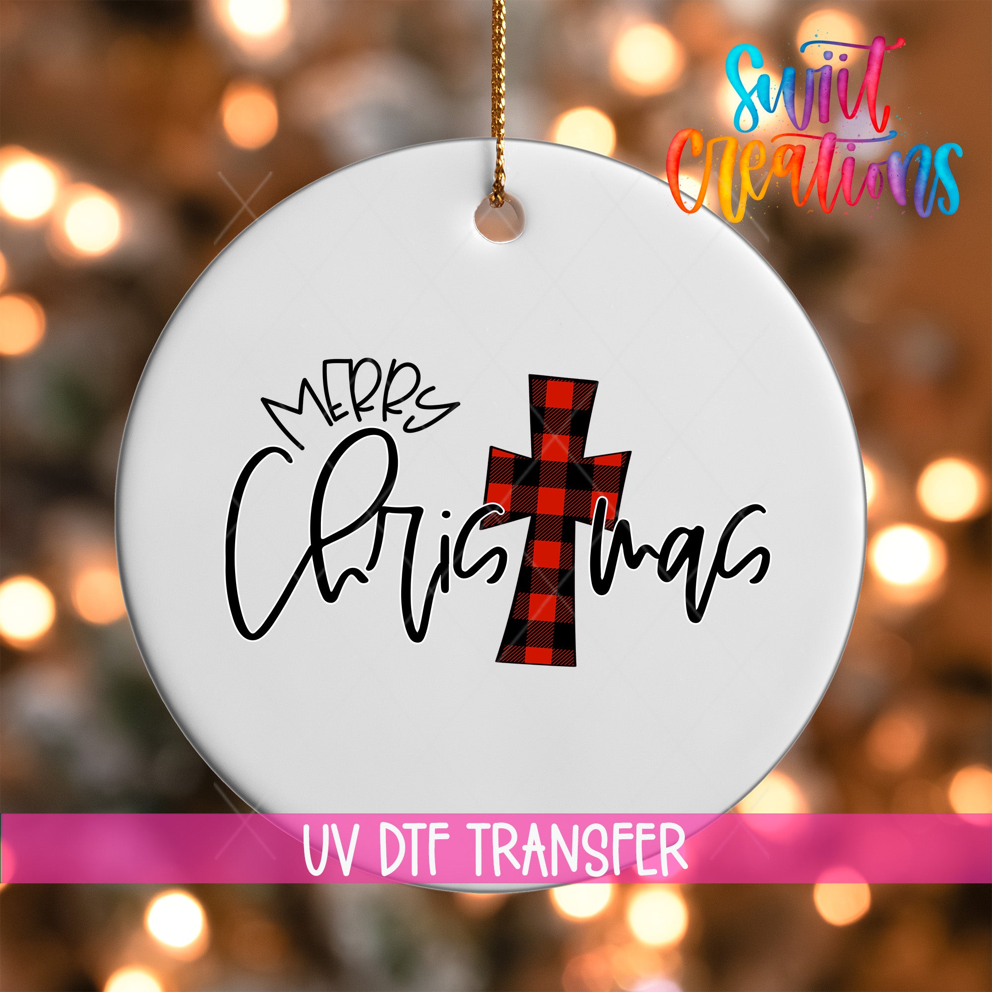 A white ornament with the text "Merry Christmas" and a red and black plaid cross design, hanging against a background of colorful lights.