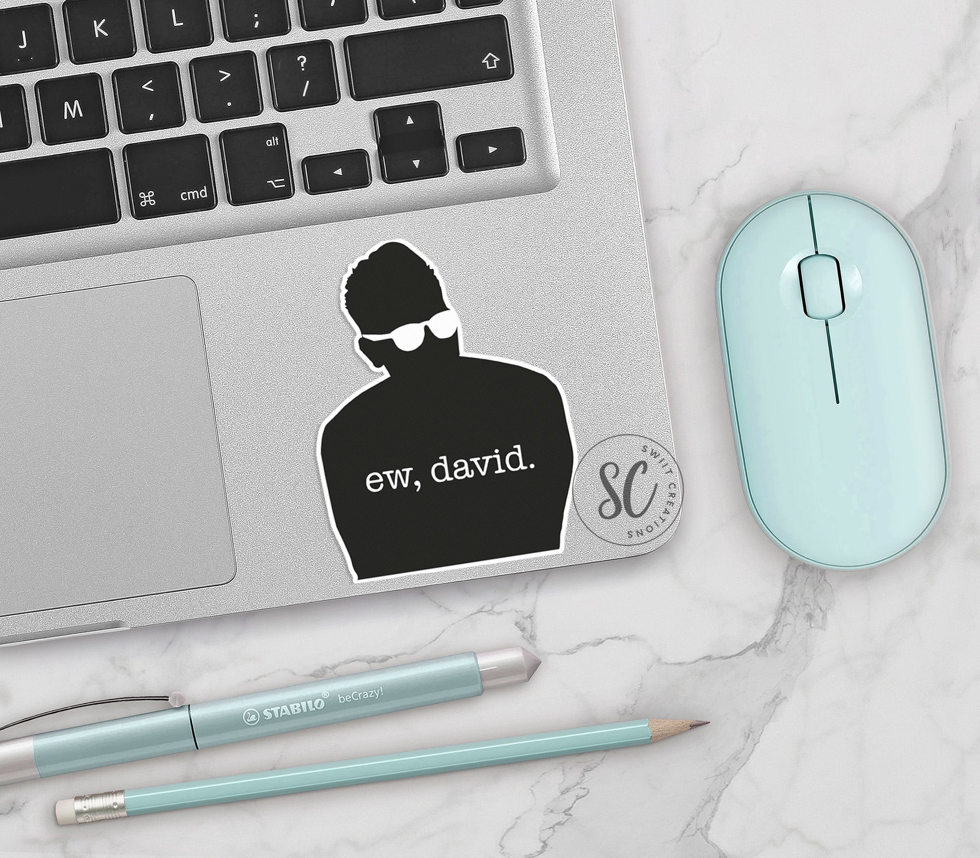 a laptop with a sticker of a man on it