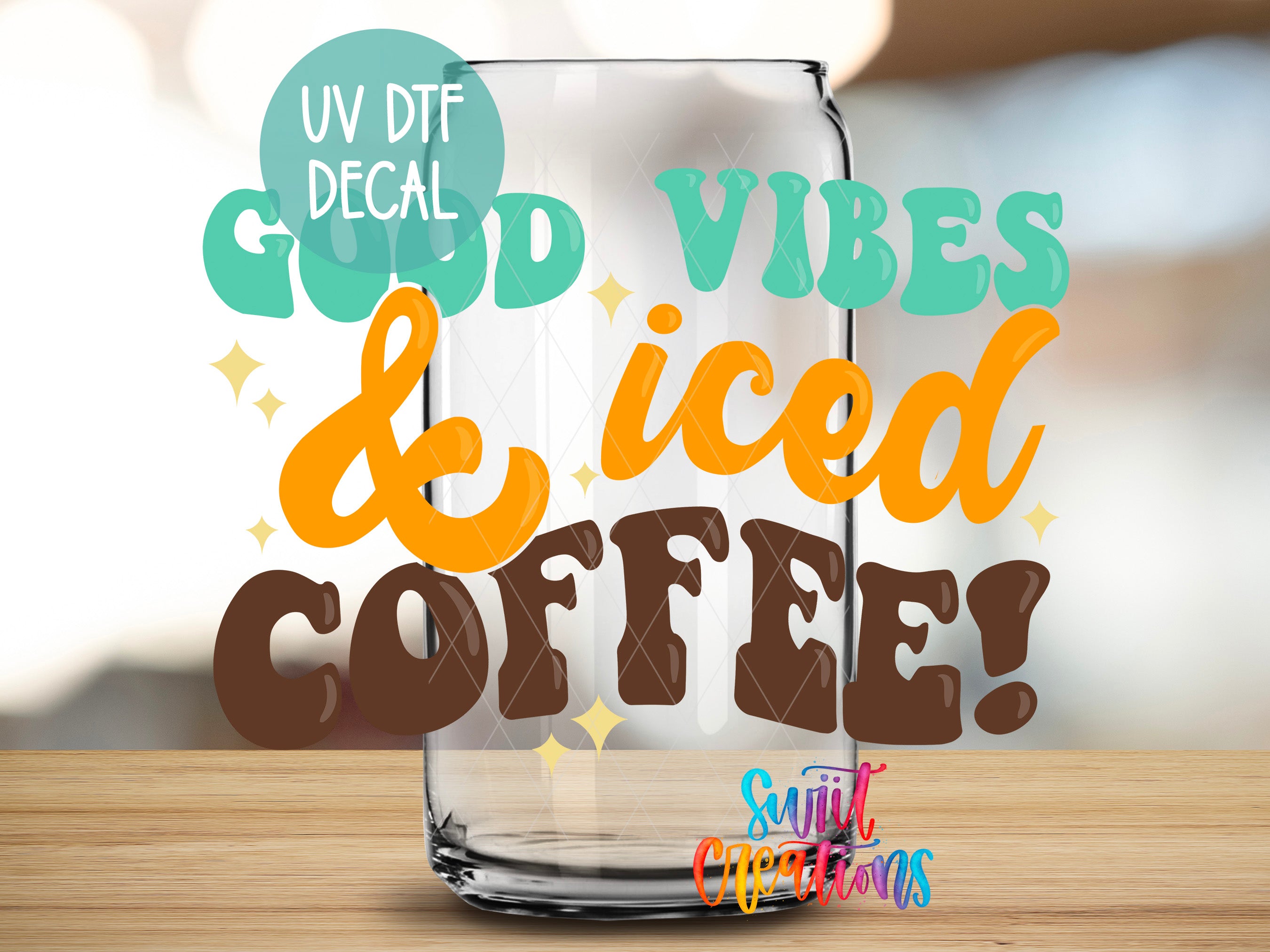 a glass of iced coffee sitting on top of a wooden table