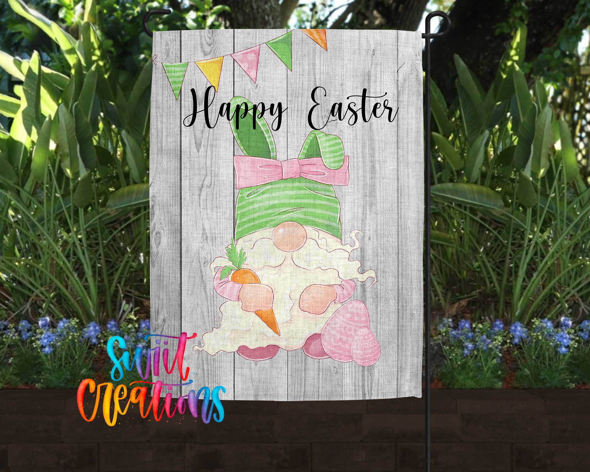 A garden flag featuring a cartoon gnome holding a carrot and a bunny, with the text "Happy Easter" displayed on the flag.