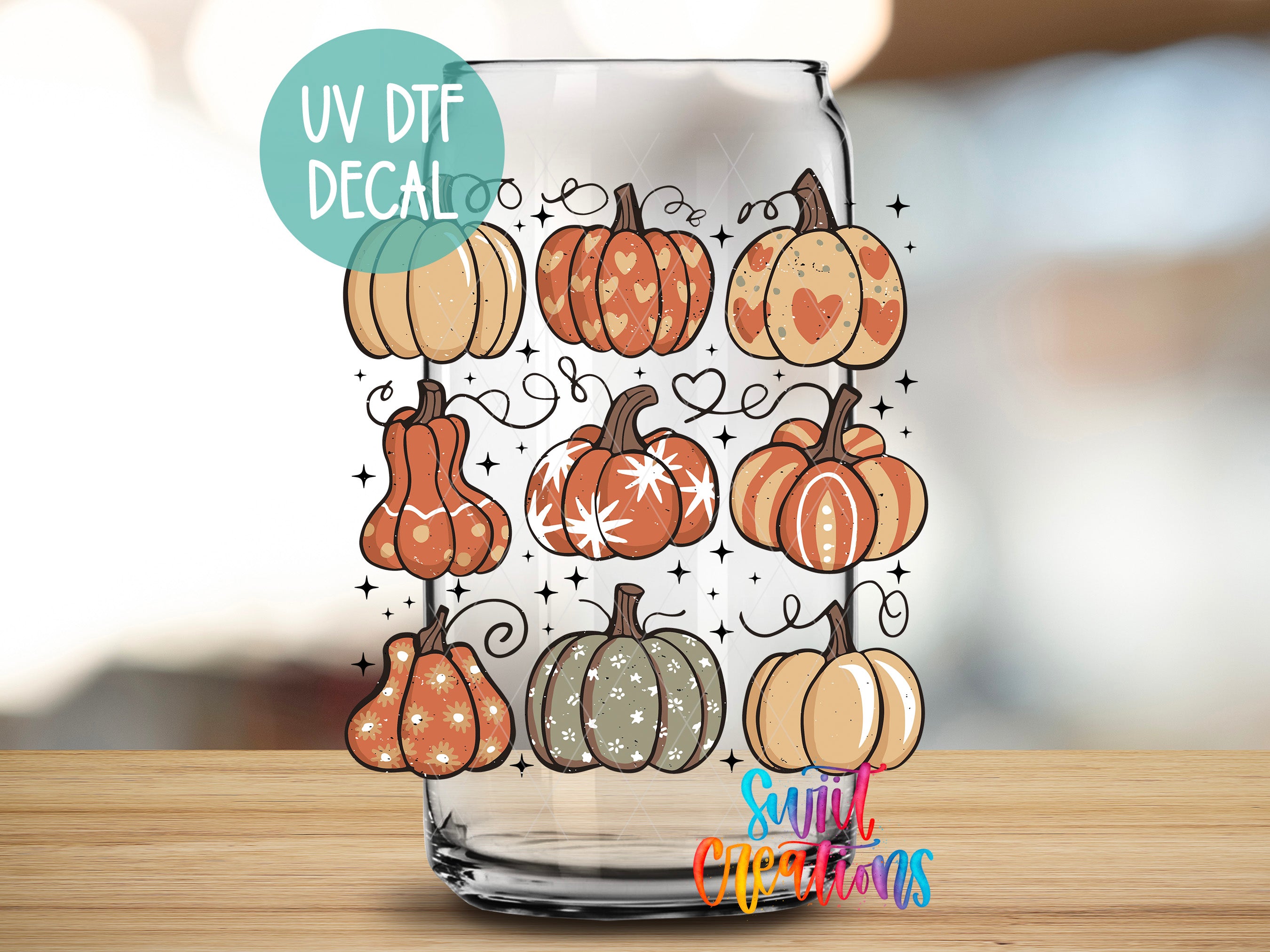 a glass jar with a UV decal of various pumpkins and hearts on it, placed on a wooden surface.