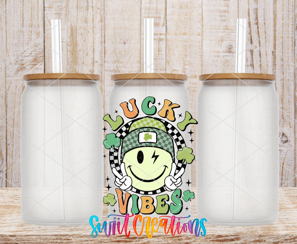 St Patricks Lucky Vibes UV DTF transfer applied to a clear glass can set from Swiit Creations