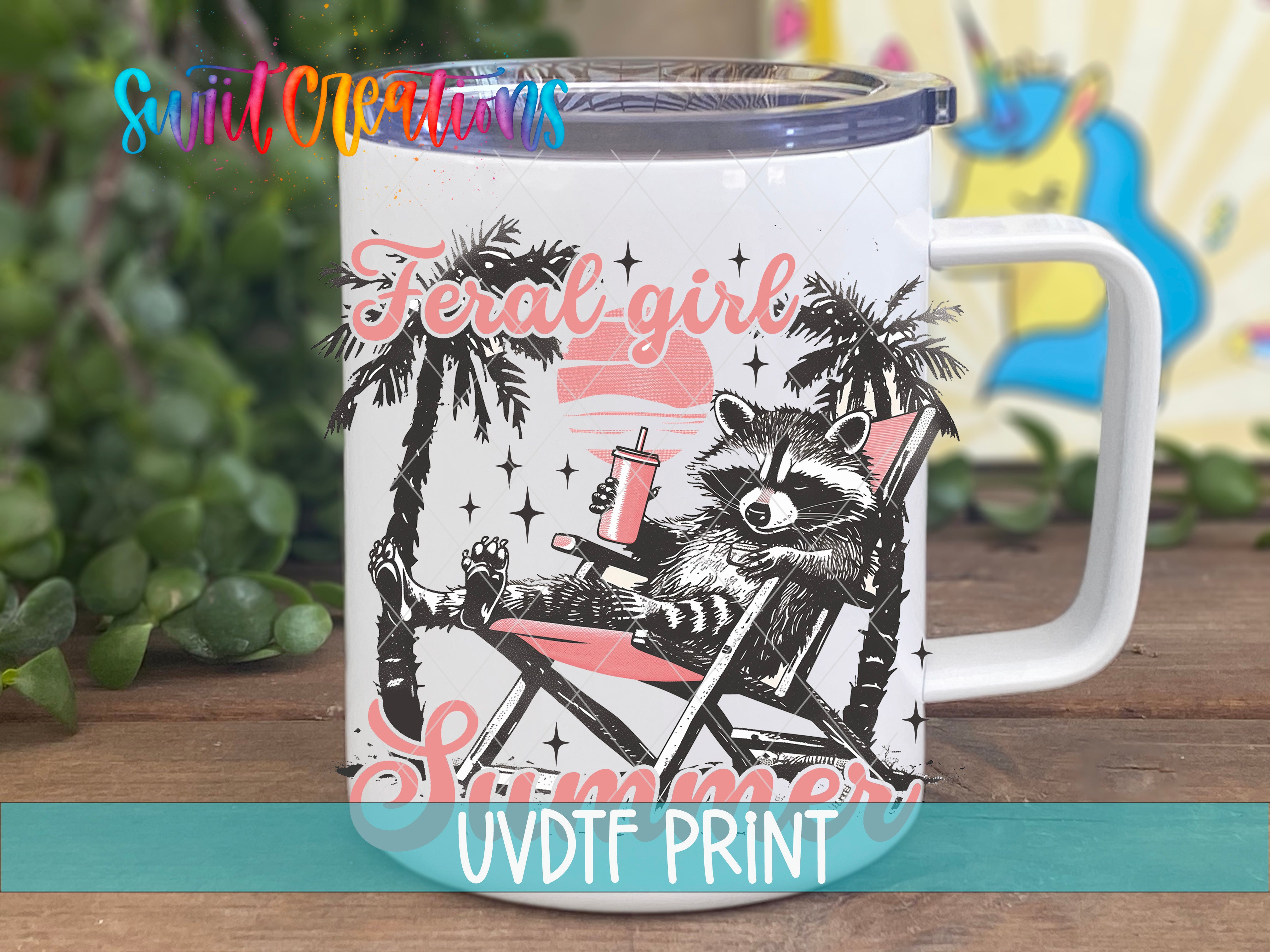 A mug with a raccoon sitting in a beach chair, surrounded by palm trees and a sunset, with the text "Feral Girl Summer UVDF PRINT" printed on it.