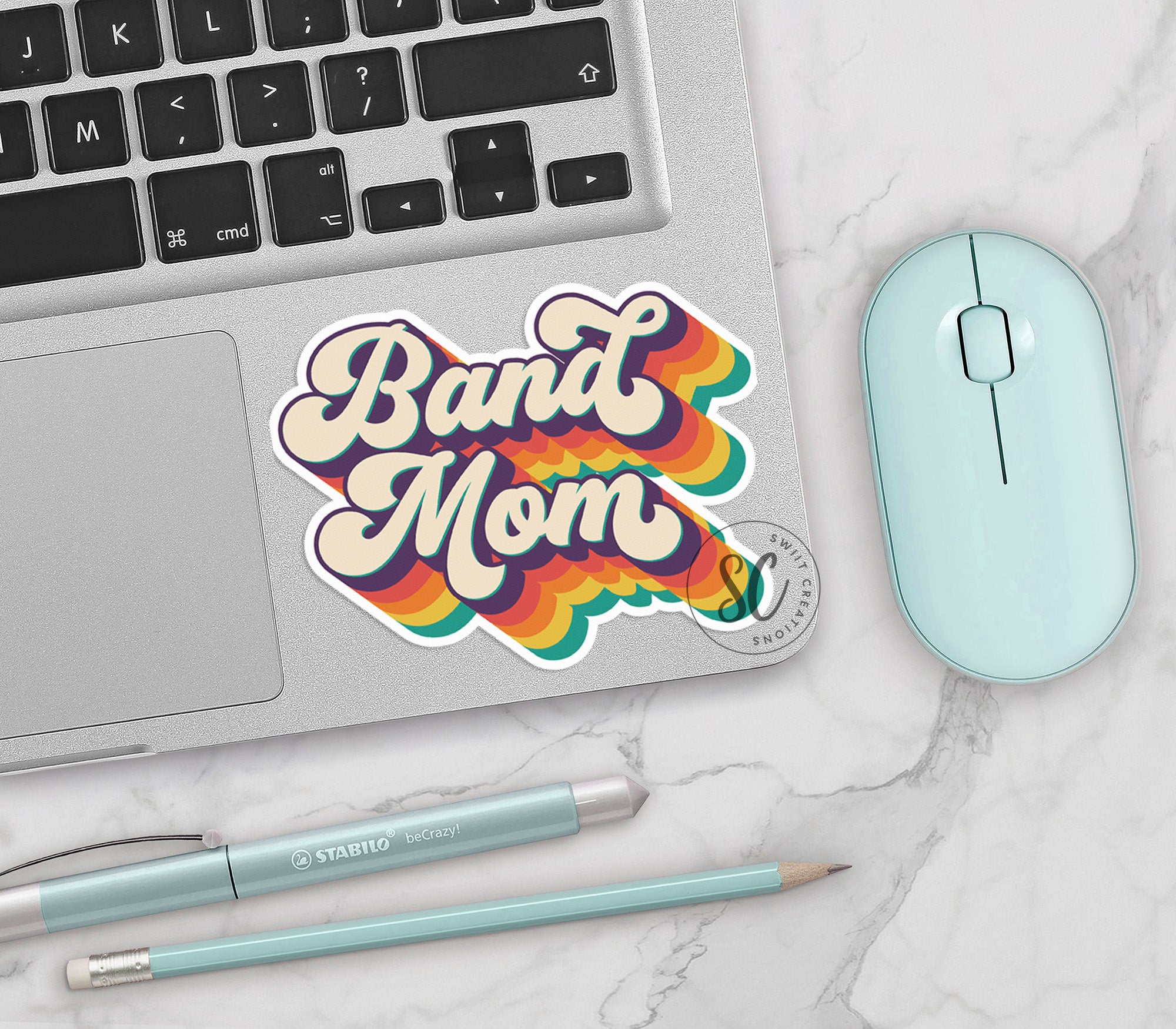 a sticker that says band mom next to a mouse