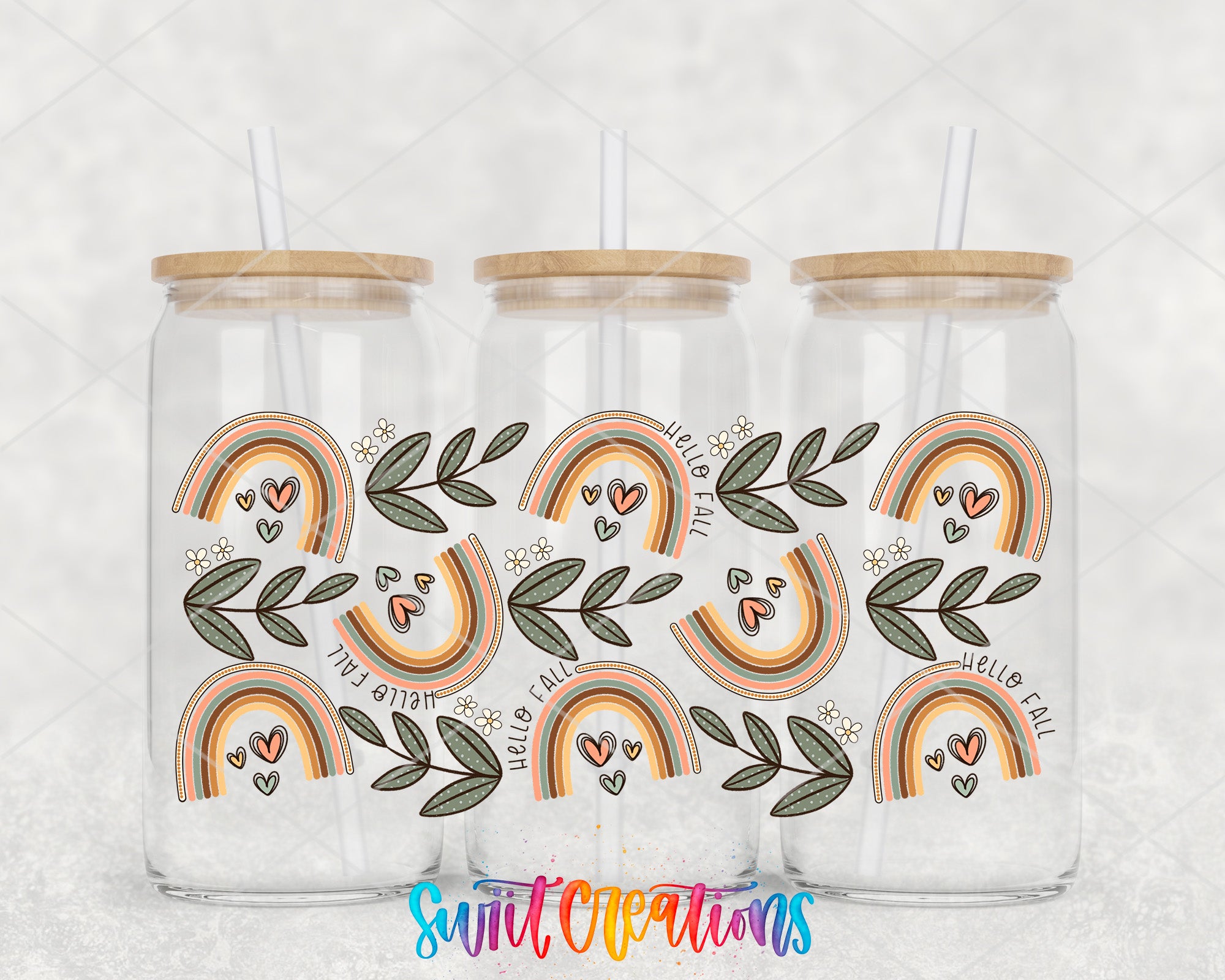 Three glass jars with wooden lids, each containing a straw. The jars have a colorful, rainbow-themed design with leaves and hearts. The text "Hello fall" is visible on the jars.