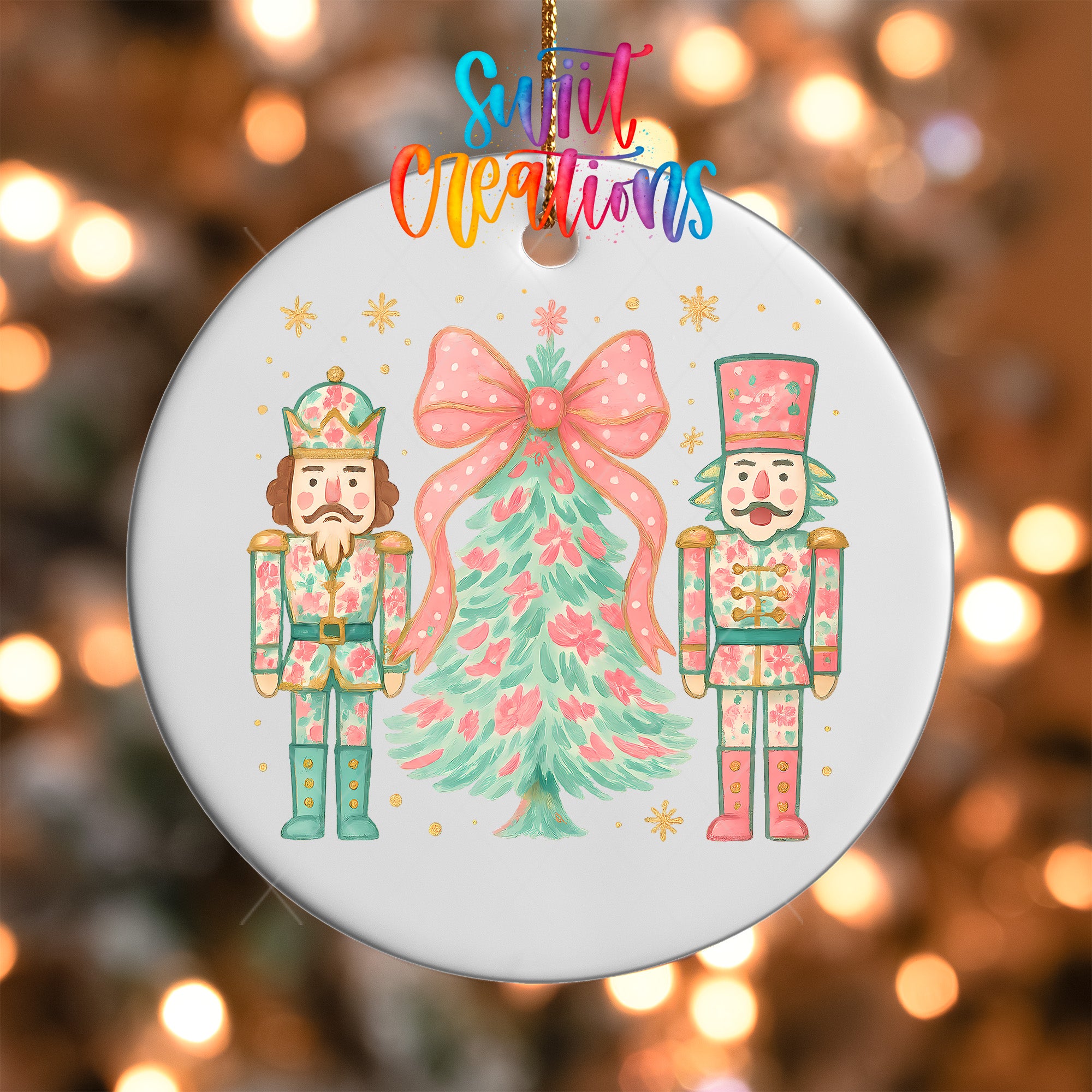 A white ornament with a Christmas tree and two nutcracker men in colorful outfits, with a colorful text overlay that reads "Sweet Creations".