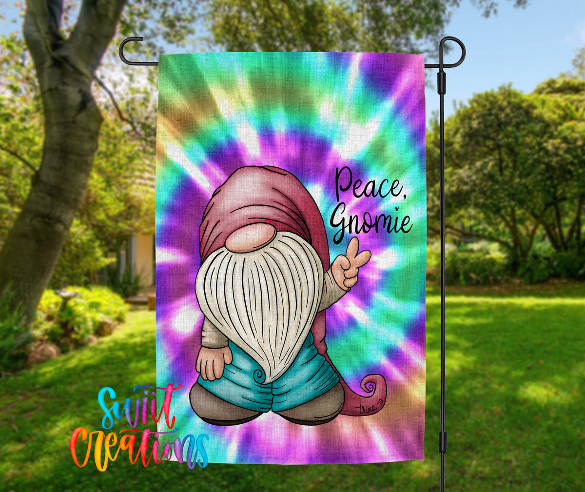 A colorful tie-dye flag featuring a gnome character with a peace sign, set against a background of trees and greenery.