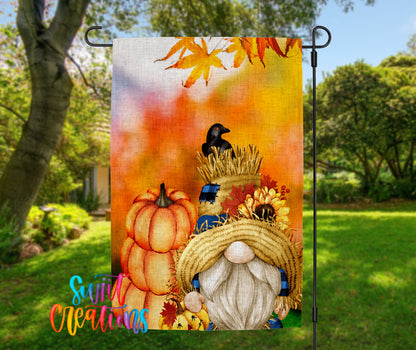 A colorful autumn-themed garden gnome is depicted in the image, surrounded by pumpkins, sunflowers, and a bird.