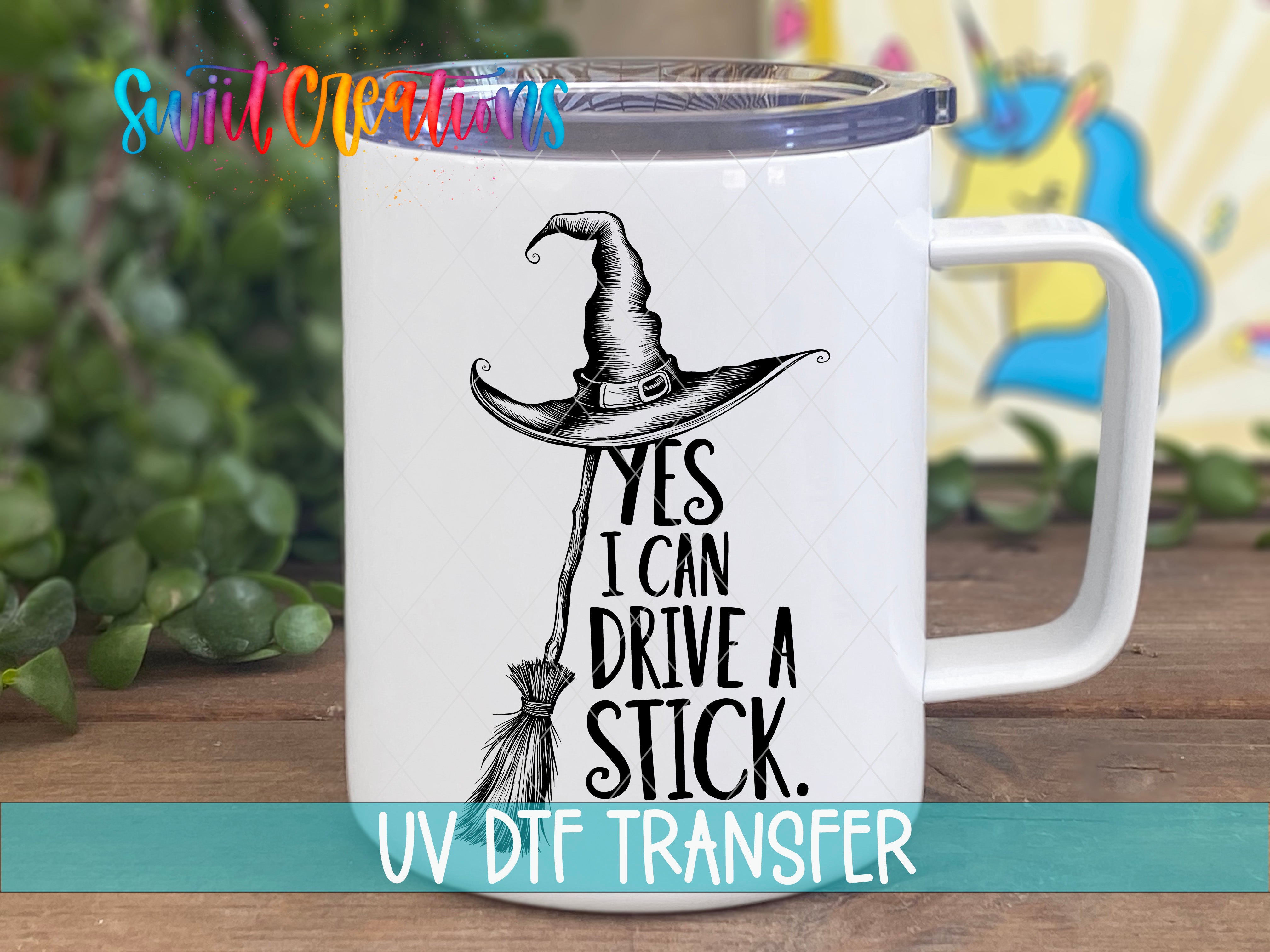 A mug with a witch's hat and the text "YES I CAN DRIVE A STICK" printed on it.