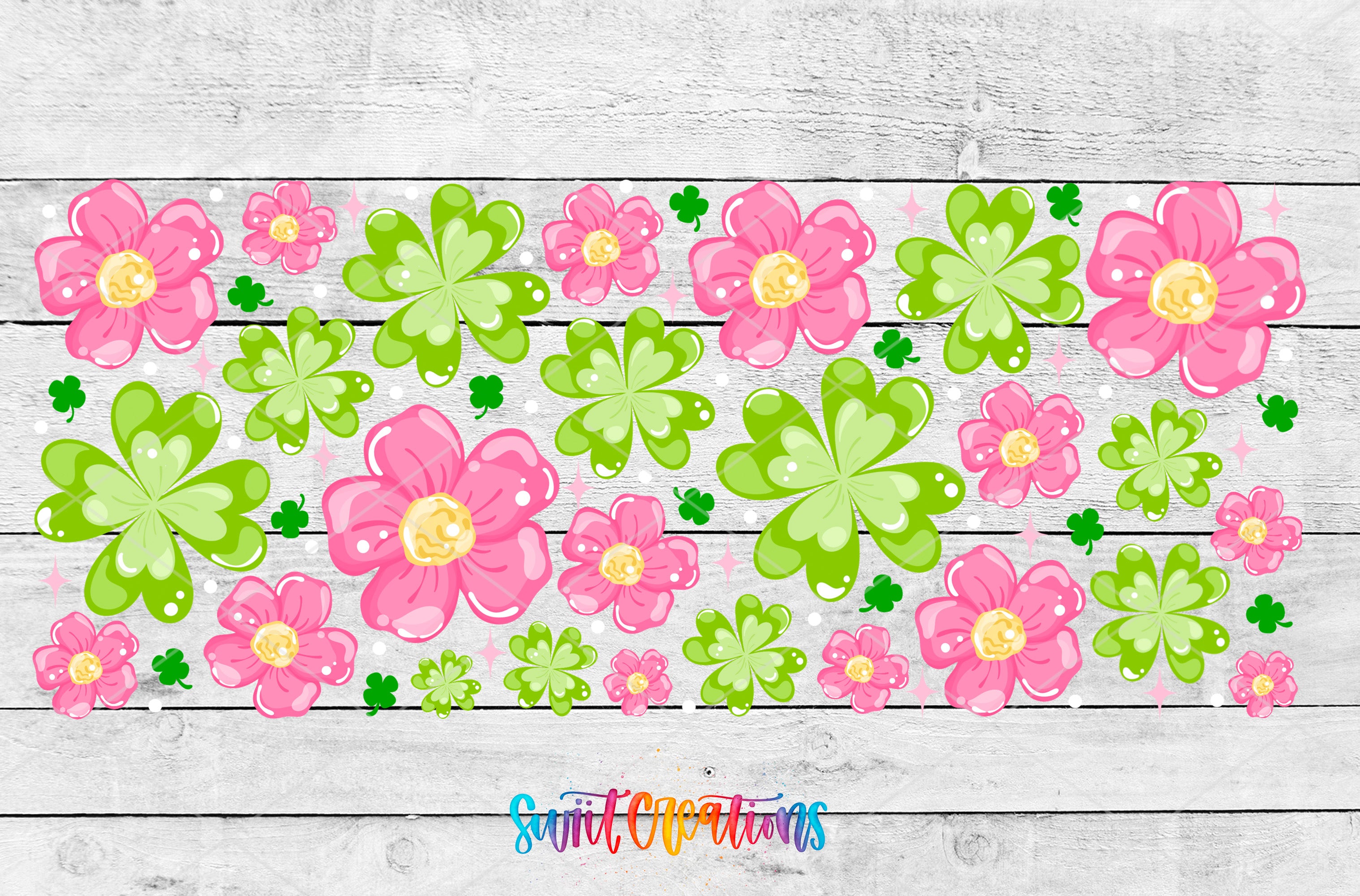 A collage of various pink and green flowers, shamrocks, and other decorative elements arranged on a wooden background.