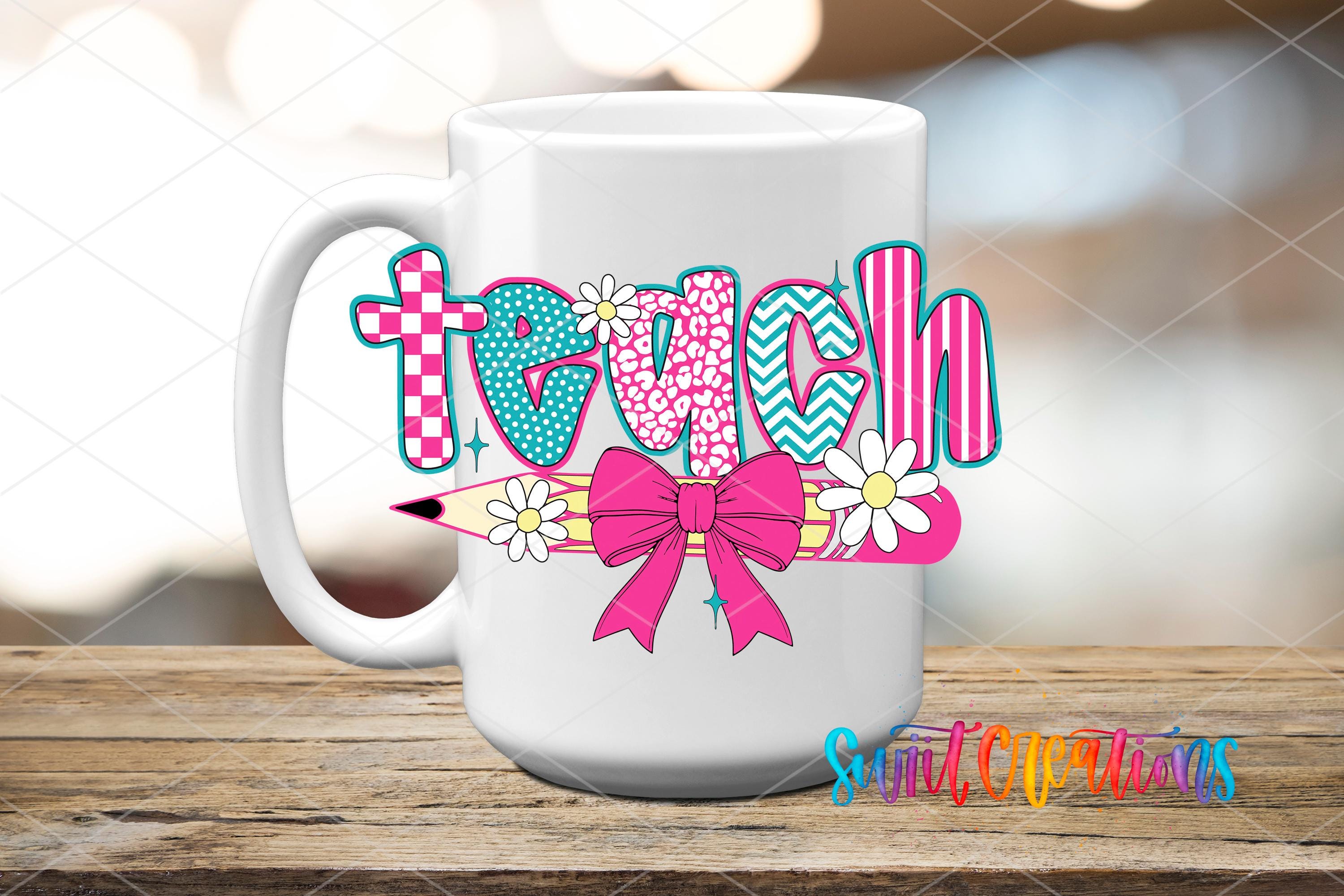 A white mug with a colorful design featuring the word "teach" and various decorative elements such as flowers and a bow.