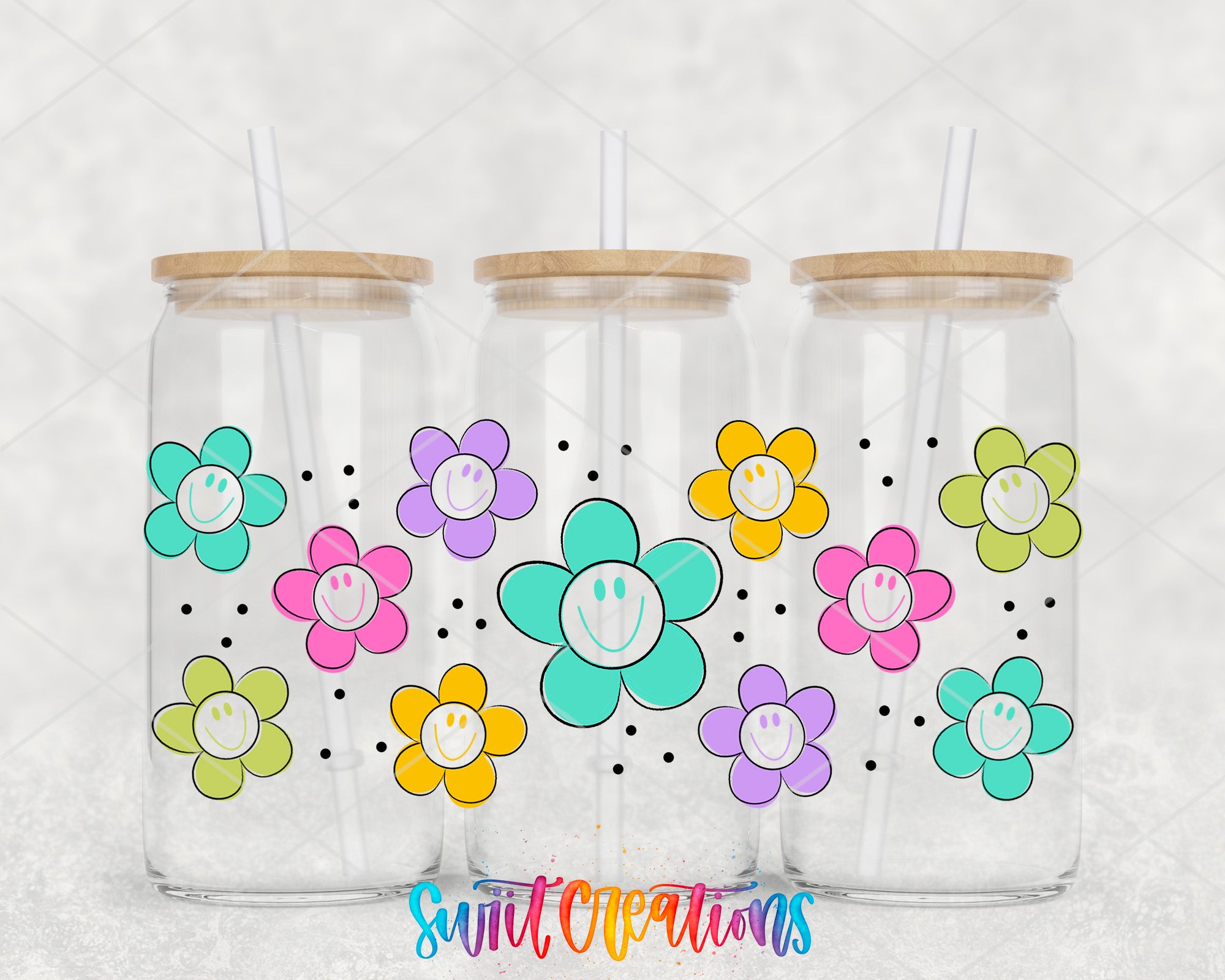 Three glass jars with wooden lids, each containing a colorful flower design and a straw.