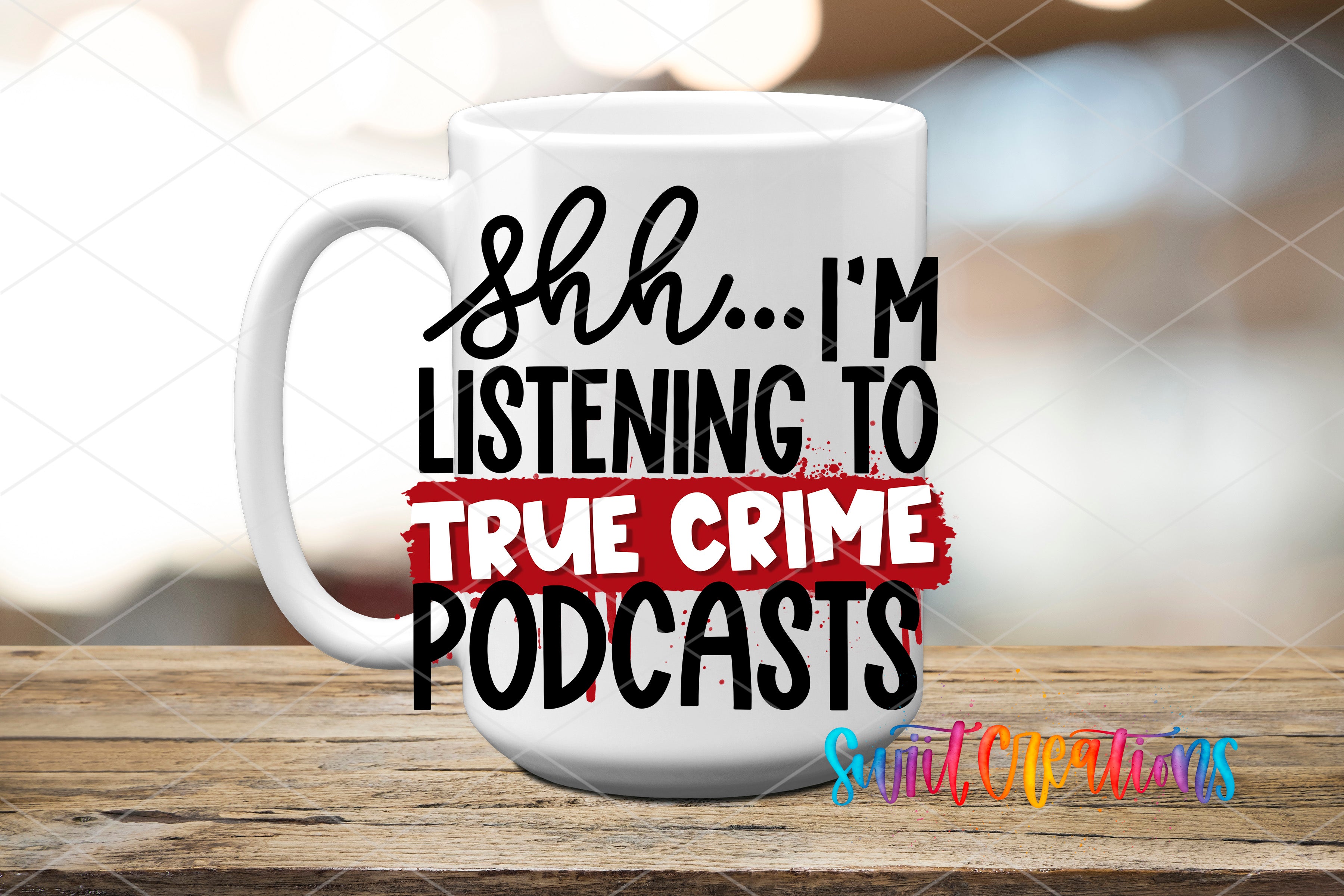 A white mug with text printed on it, placed on a wooden surface.