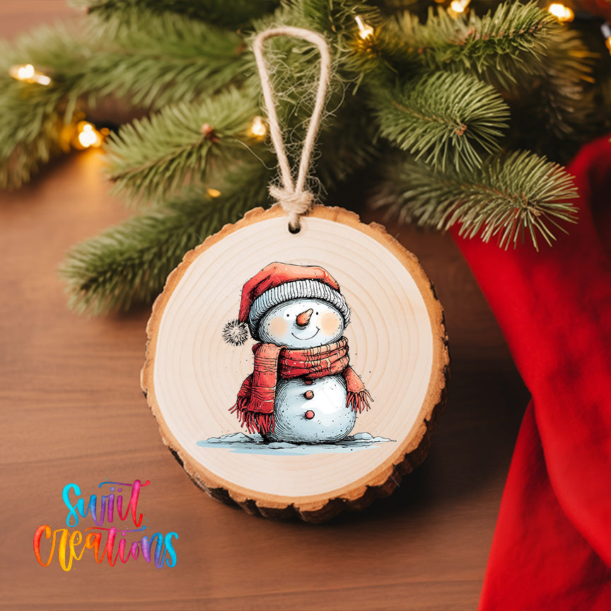 A wooden ornament featuring a snowman is hanging on a Christmas tree, with a red cloth visible in the background.