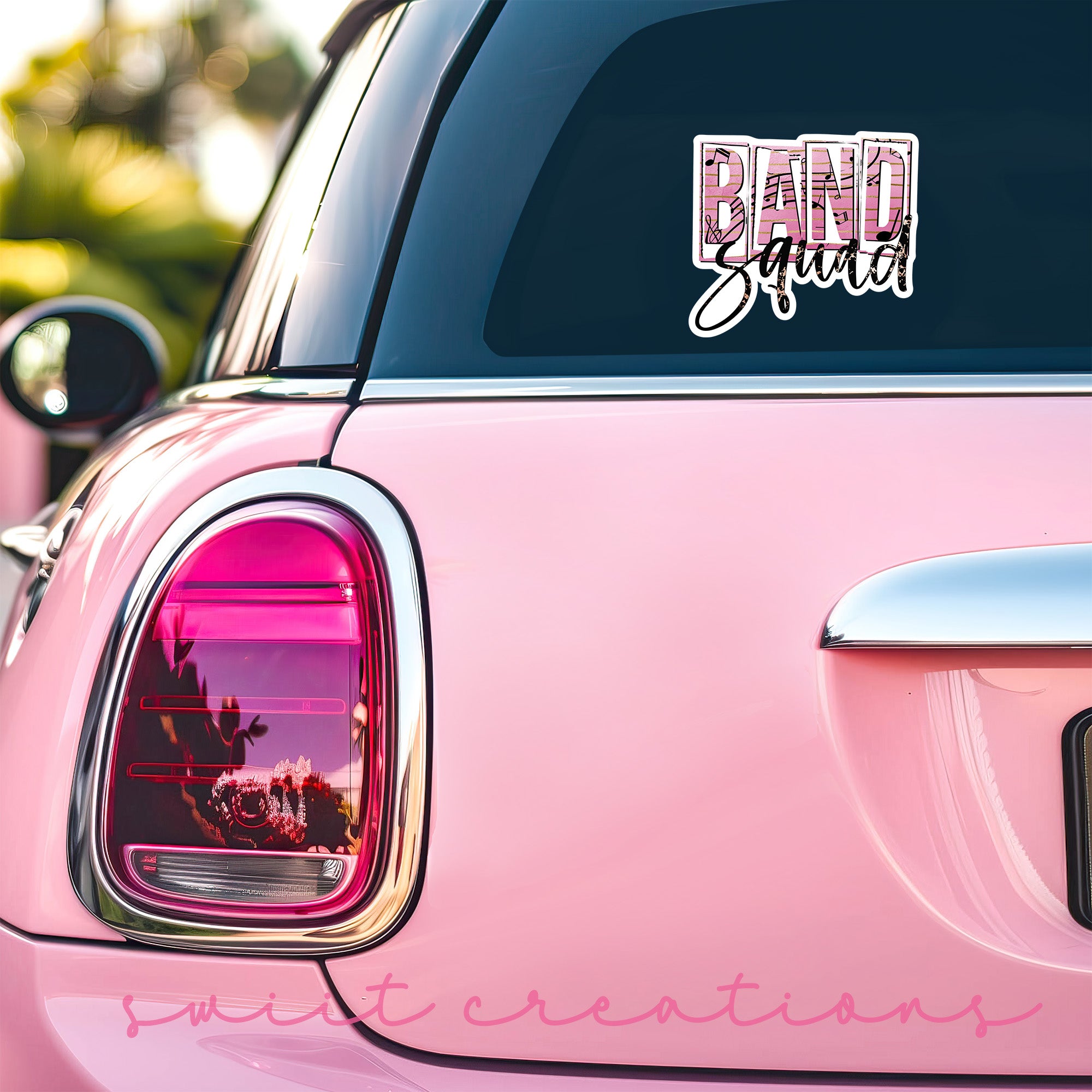 a pink car with a sticker that says band squad