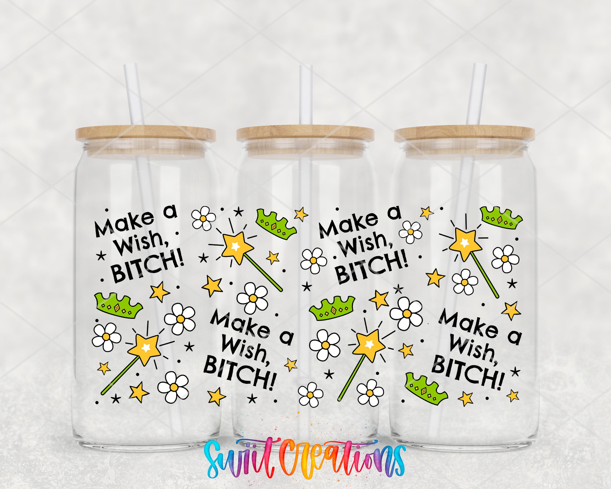Three clear glass tumblers with wooden lids, each featuring a whimsical design and text that says "Make a Wish, Bitch!"