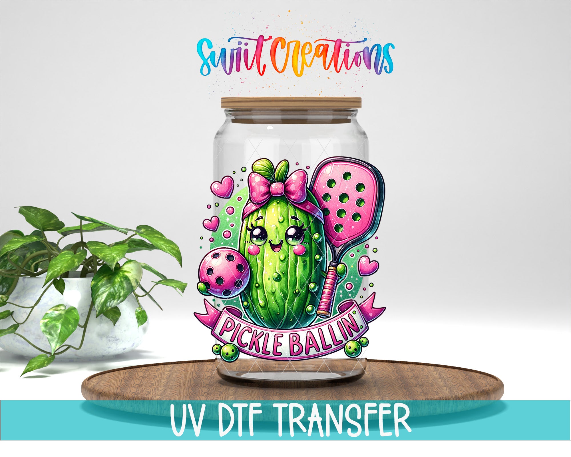 A glass jar with a colorful illustration of a pickle ballin character, surrounded by various decorative elements, placed on a wooden surface.