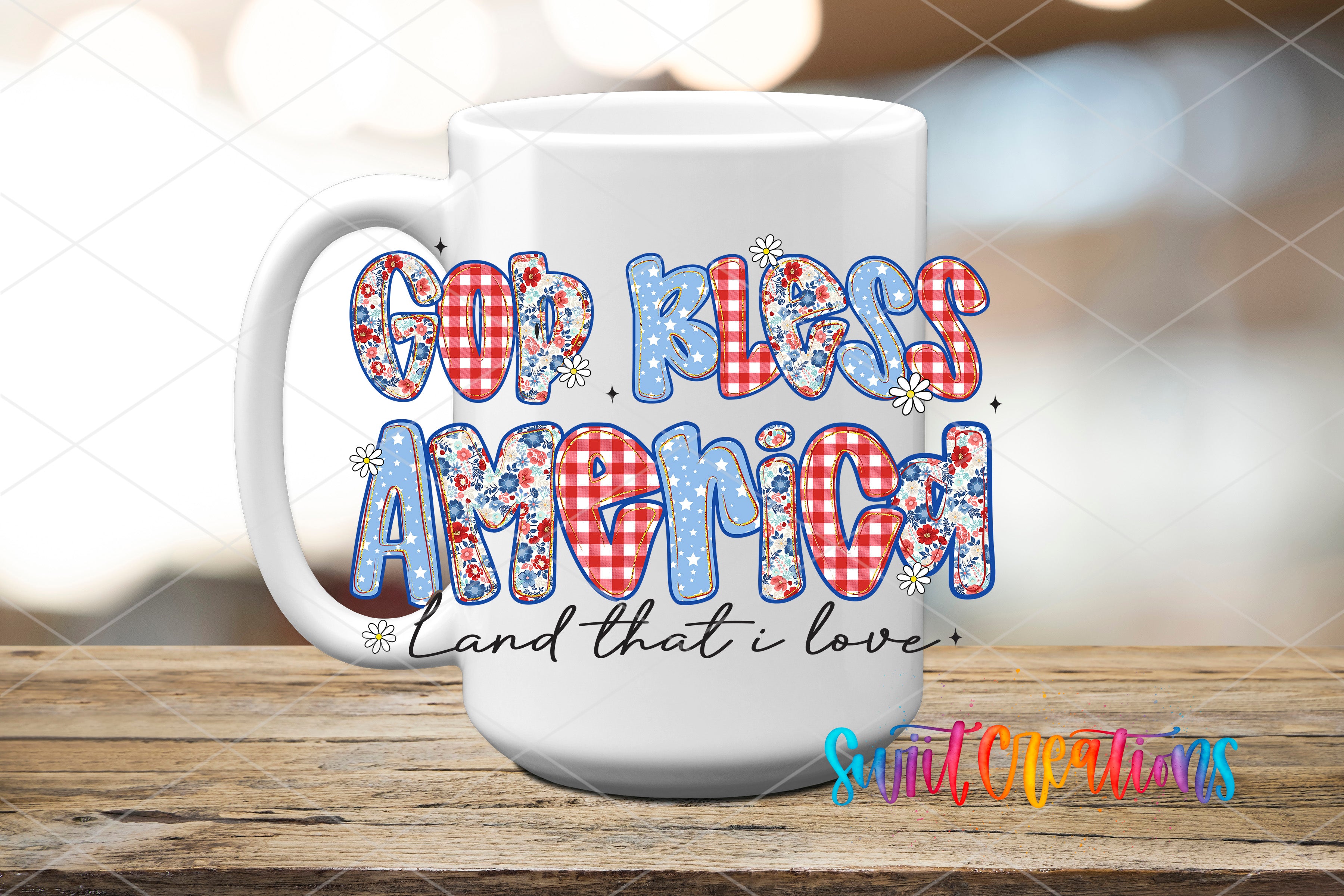 A white mug with the text "God Bless America" printed on it, along with a floral design.