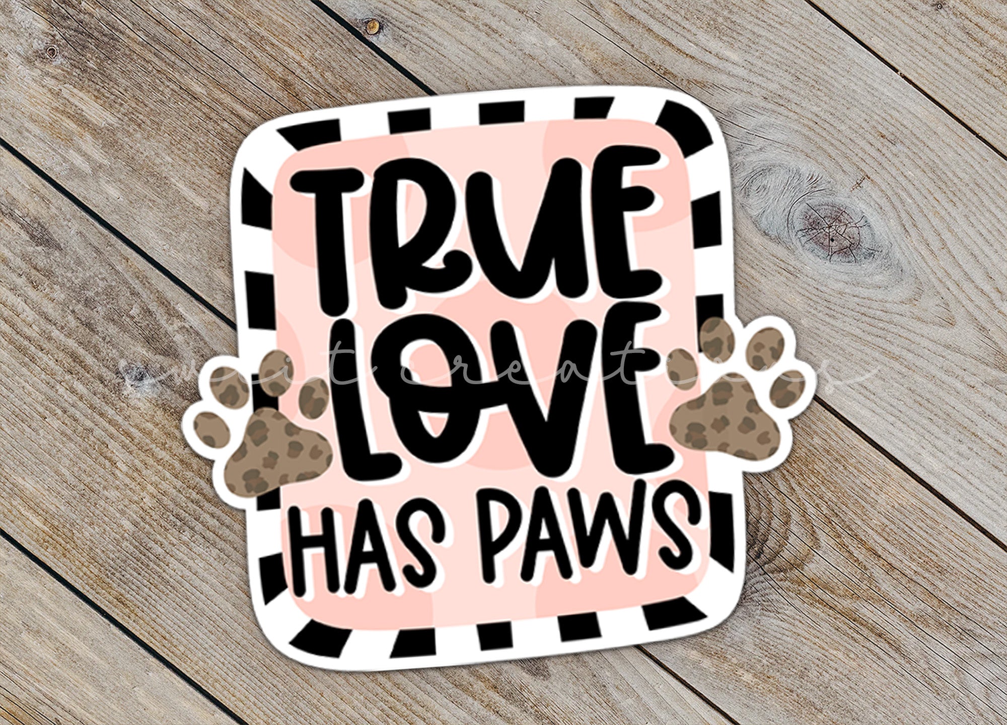 a sticker that says true love has paws
