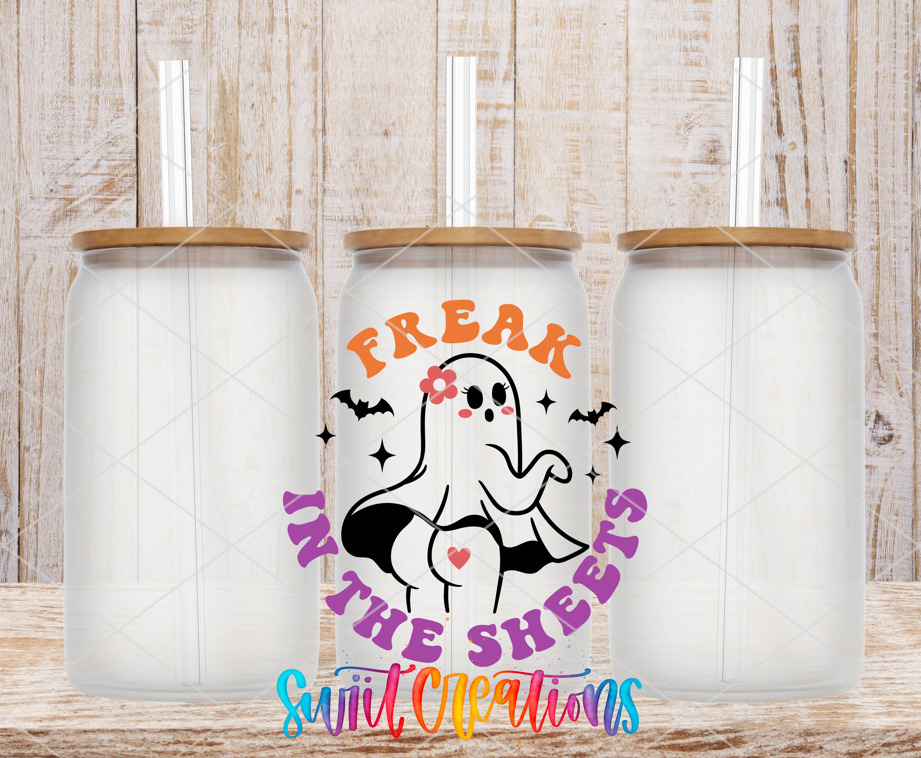 three white glass tumblers with brown lids, each with a straw sticking out of the top. The tumblers are arranged in a row, and there is a graphic design on the front of each tumbler that says "FREAK IN THE SHEETS" in a colorful, stylized font.
