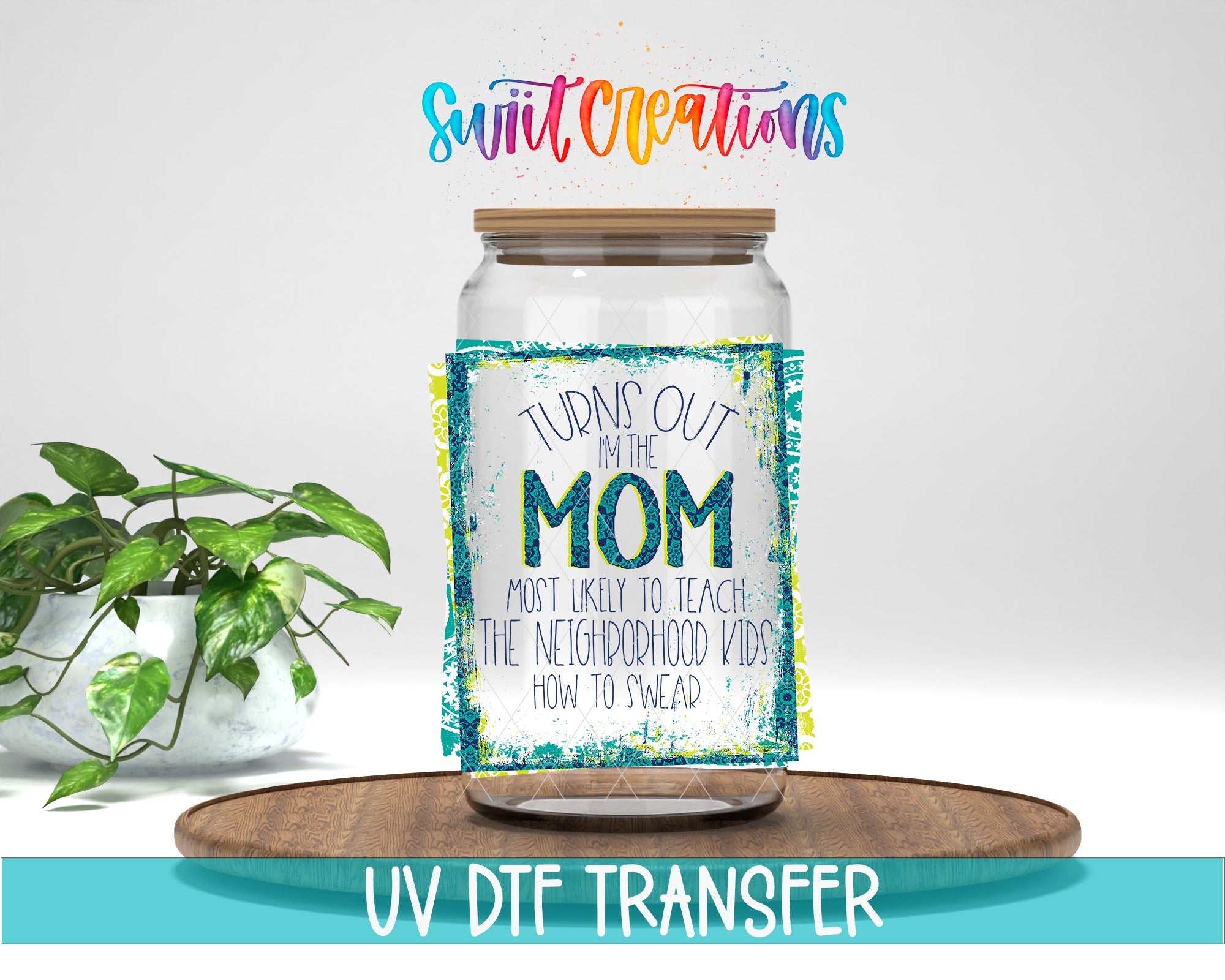 a glass jar with a label that says "TURNS OUT IN THE MOM" and "MOST LIKELY TO TEACH THE NEIGHBORHOOD KIDS HOW TO SWER". The jar is placed on a wooden tray, and there is a potted plant in the background.
