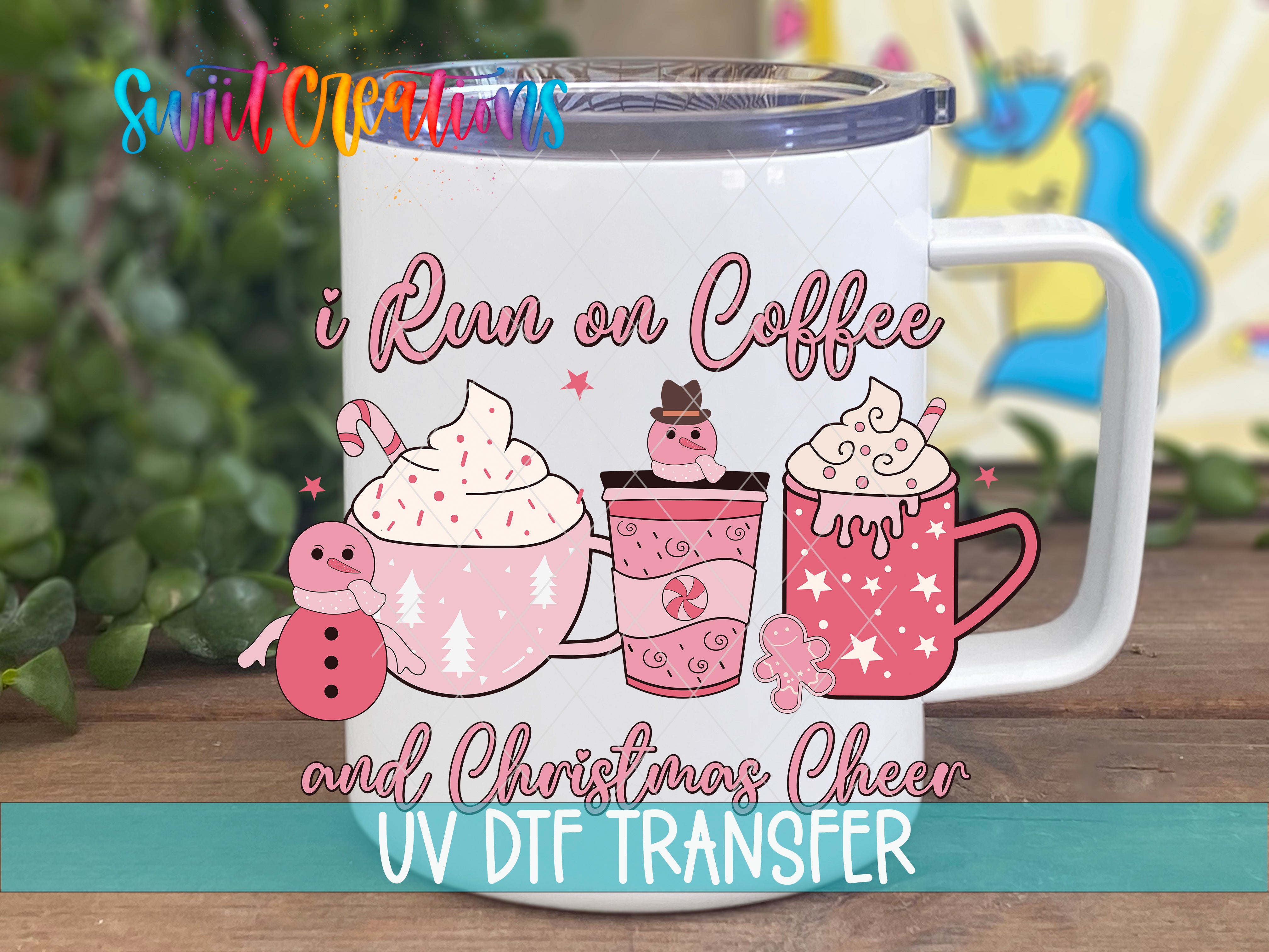 A white mug with a colorful illustration of hot beverages, including a cup of coffee, a mug of hot chocolate, and a mug of whipped cream, along with a snowman and a gingerbread man. The mug also has the text "I Run on Coffee and Christmas Cheer" and "UV DIT TRANSFER" printed on it.