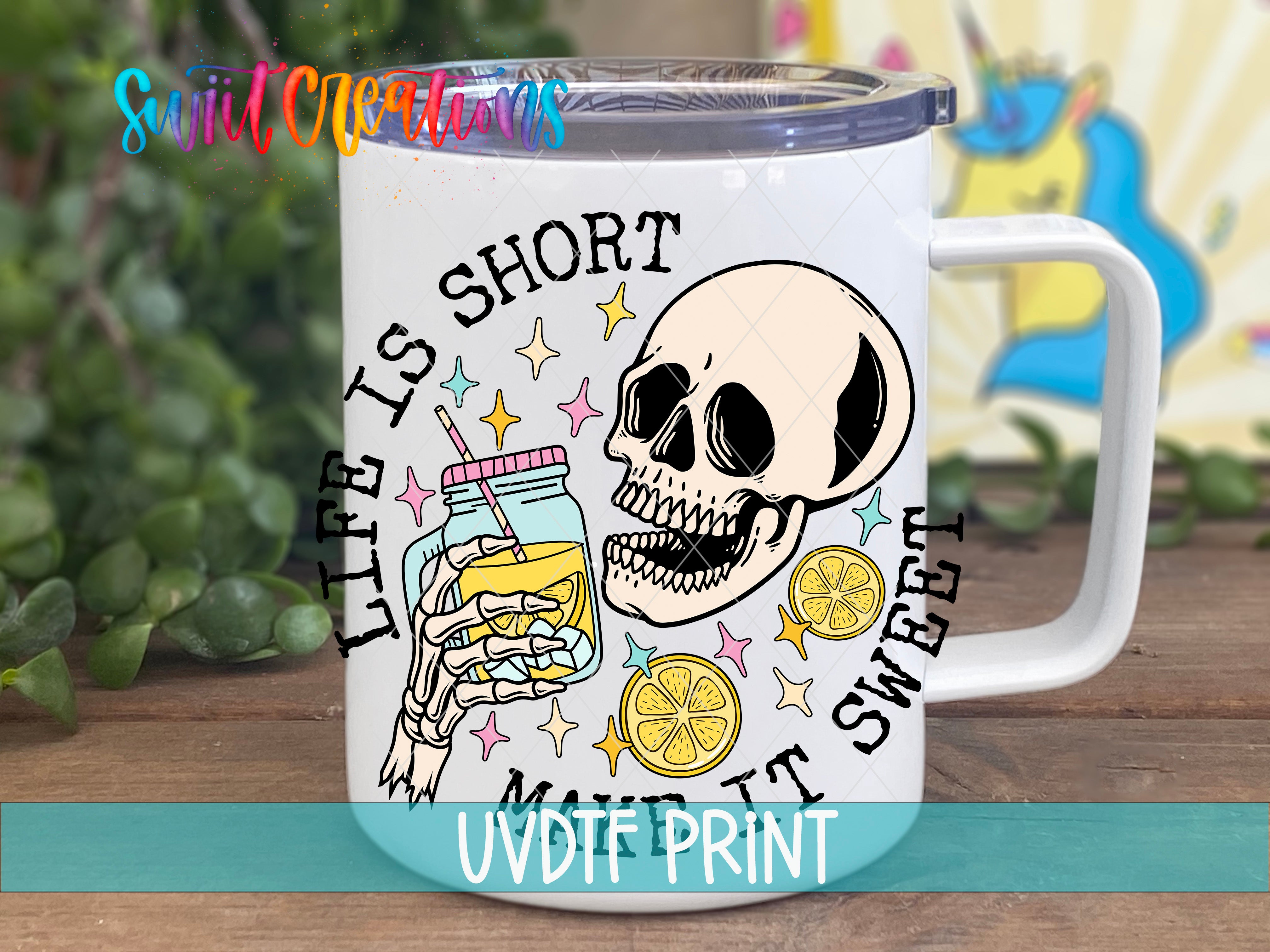 A mug with a skull and a jar of lemonade, along with the text "Life is short, sweet" and "It's sweet" printed on it.